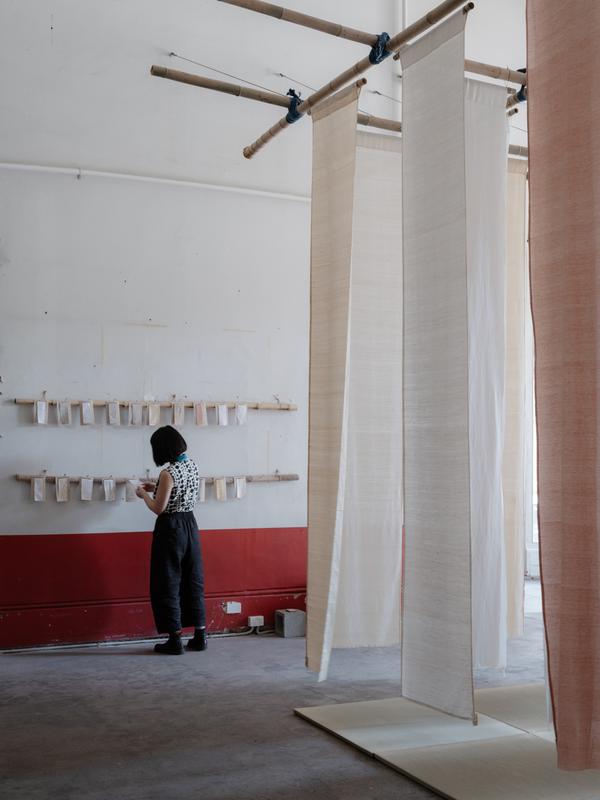 Person in the exhibition of hanging fabric