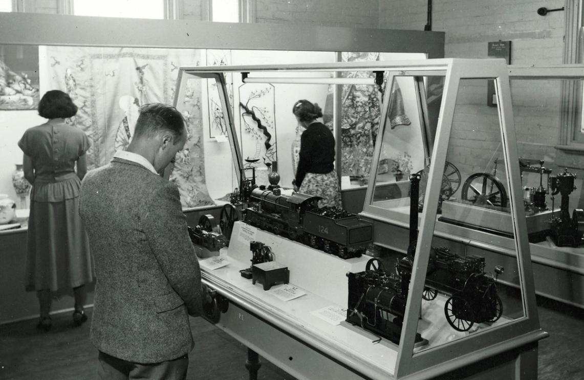 Close up black and white photograph glass display cabinet housing geological specimens