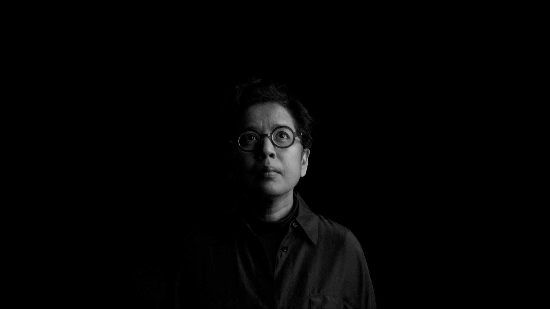 Half lit face in the dark.