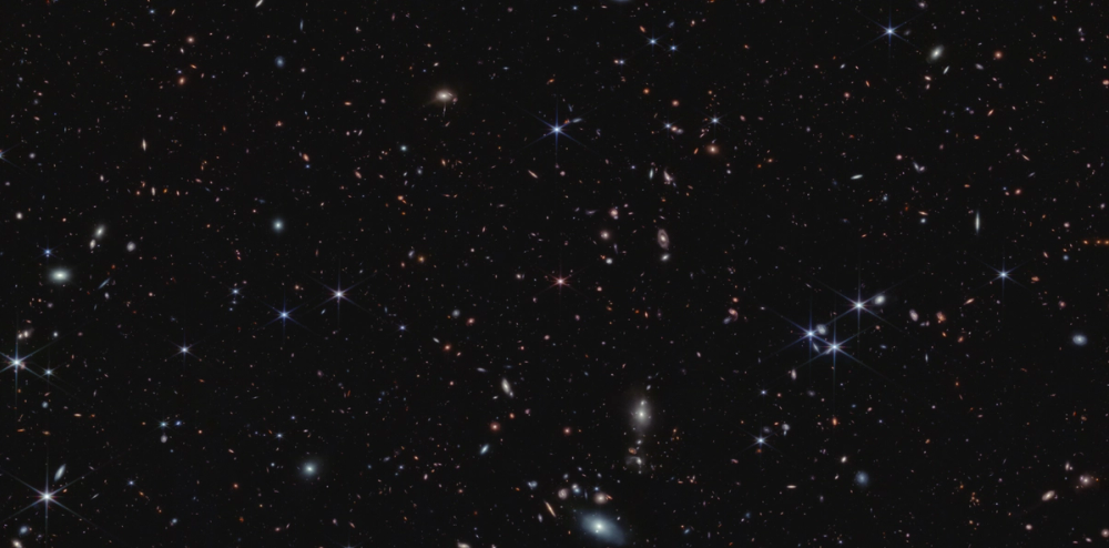 Multiple small galaxies against a black background