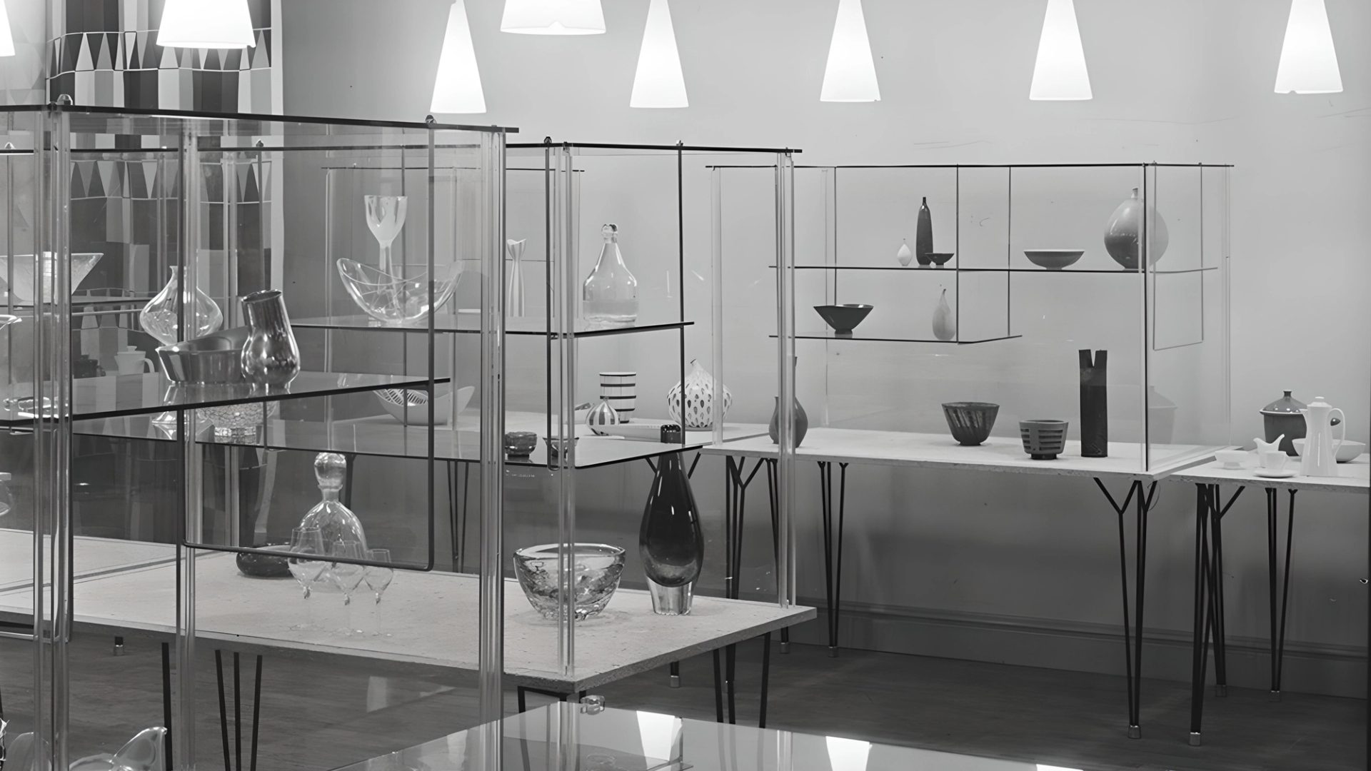 Glass shelves with homewares on them.