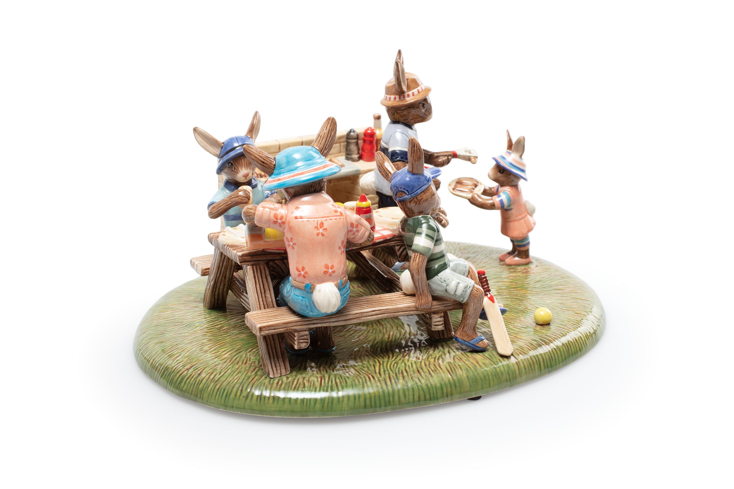 White mould cast porcelain figurine of rabbit family at the bbq table