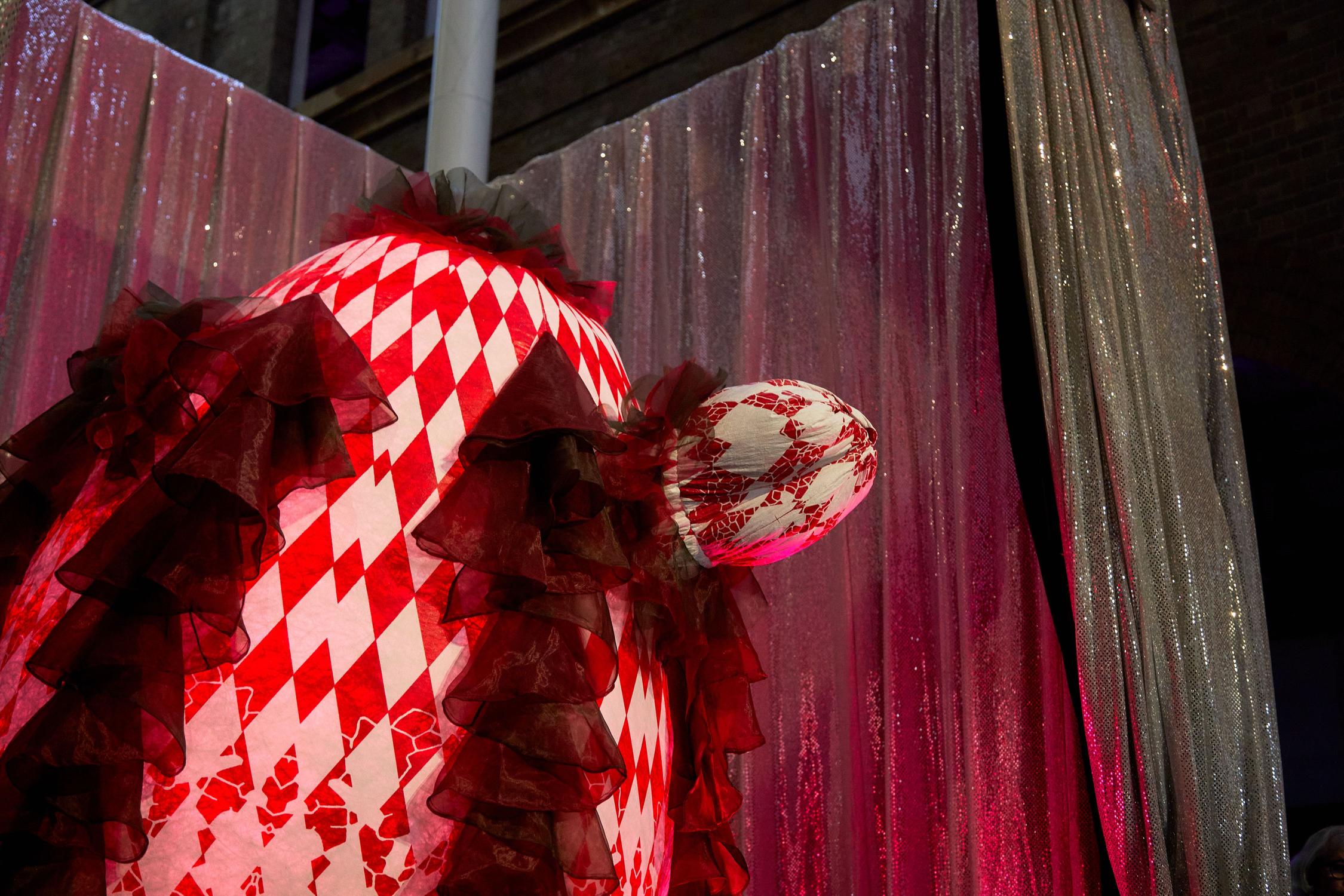 A large inflatable costume with right and red check diamond pattern.