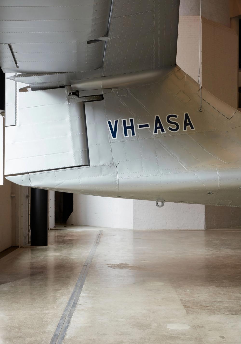 Registration code text ‘VH-ASA’ on the tail of silver plane.