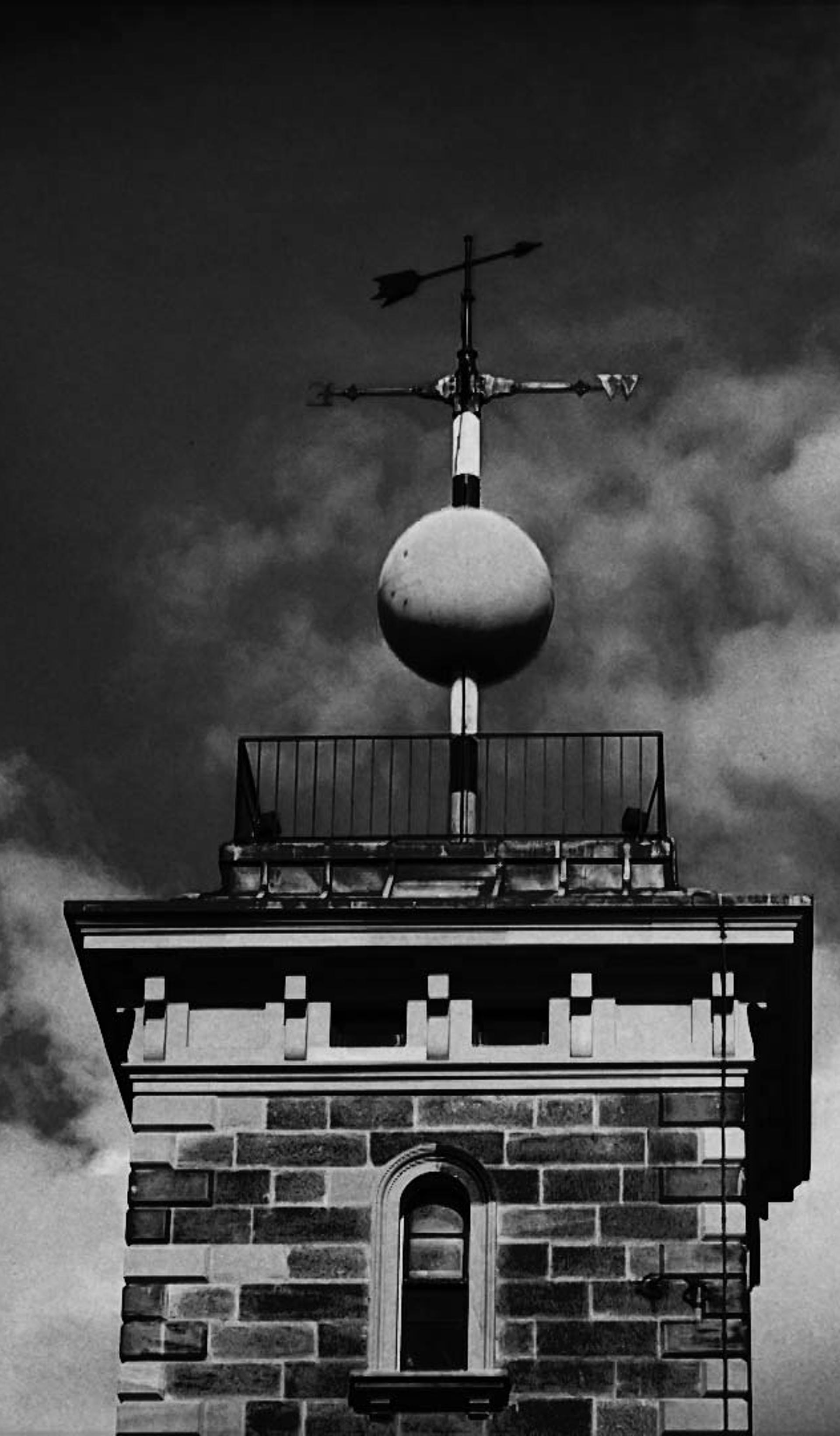 A weather pane above a building.