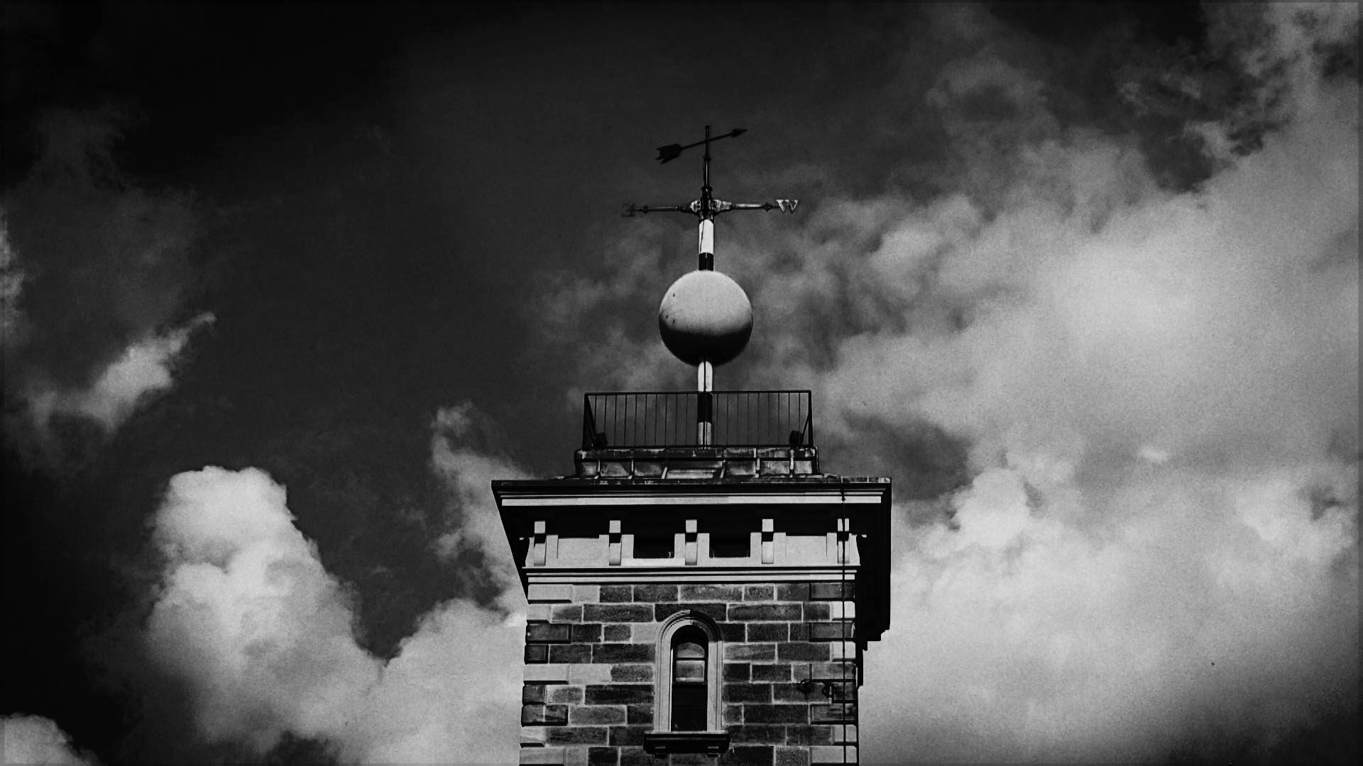 A weather pane above a building.