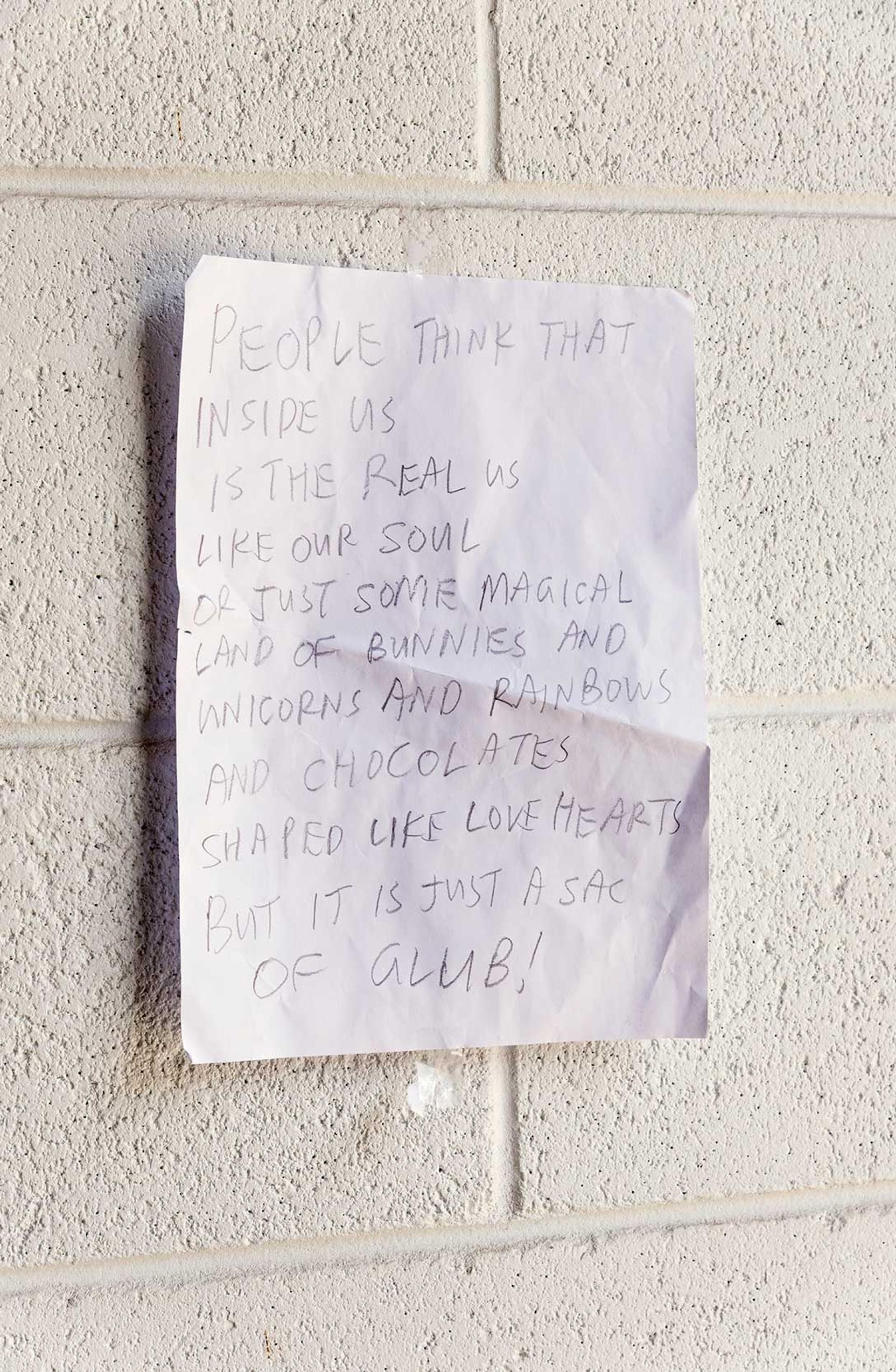 Note reading “PEOPLE THINK THAT INSIDE US IS THE REAL US LIKE OUR SOUL OR JUST SOME MAGICAL LAND OF BUNNIES AND UNICORNS AND RAINBOWS AND CHOCOLATE SHAPED LIKE LOVE HEARTS BUT IT’S JUST A SACK OF GLUB!”