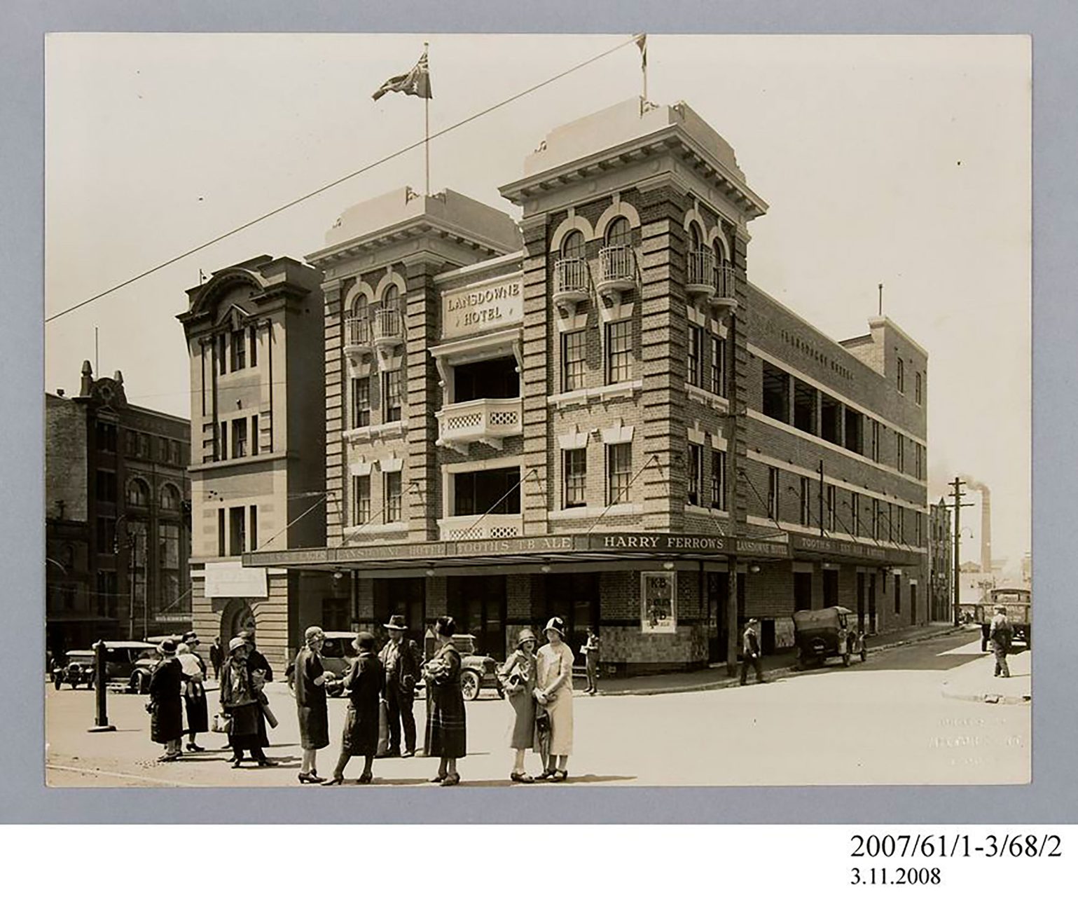 Photographic print, black & white, exterior of Lansdowne Hotel, Chippendale, 1926. There are a group of people dressed in the style of the time at the front of the hotel.
