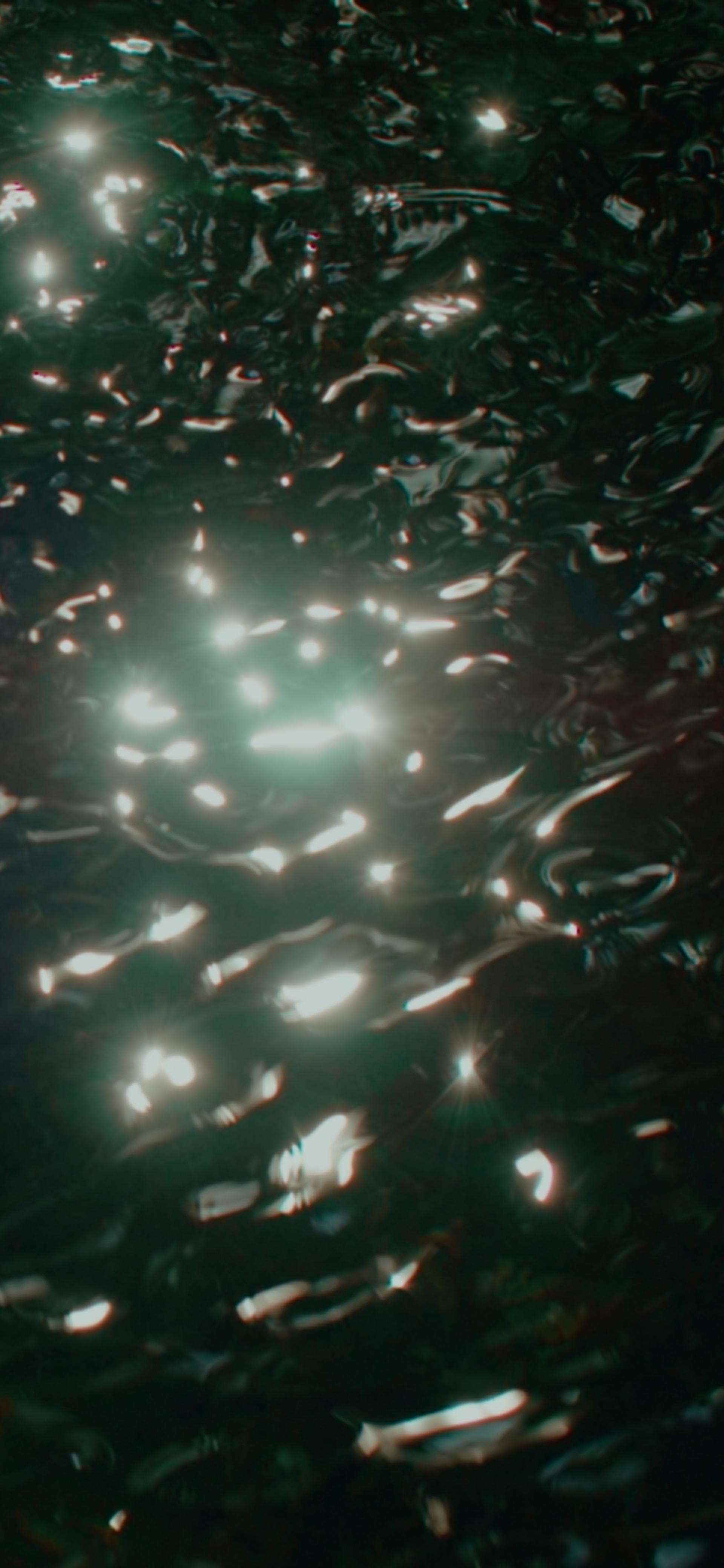 Sun reflected upon ripples of dark water
