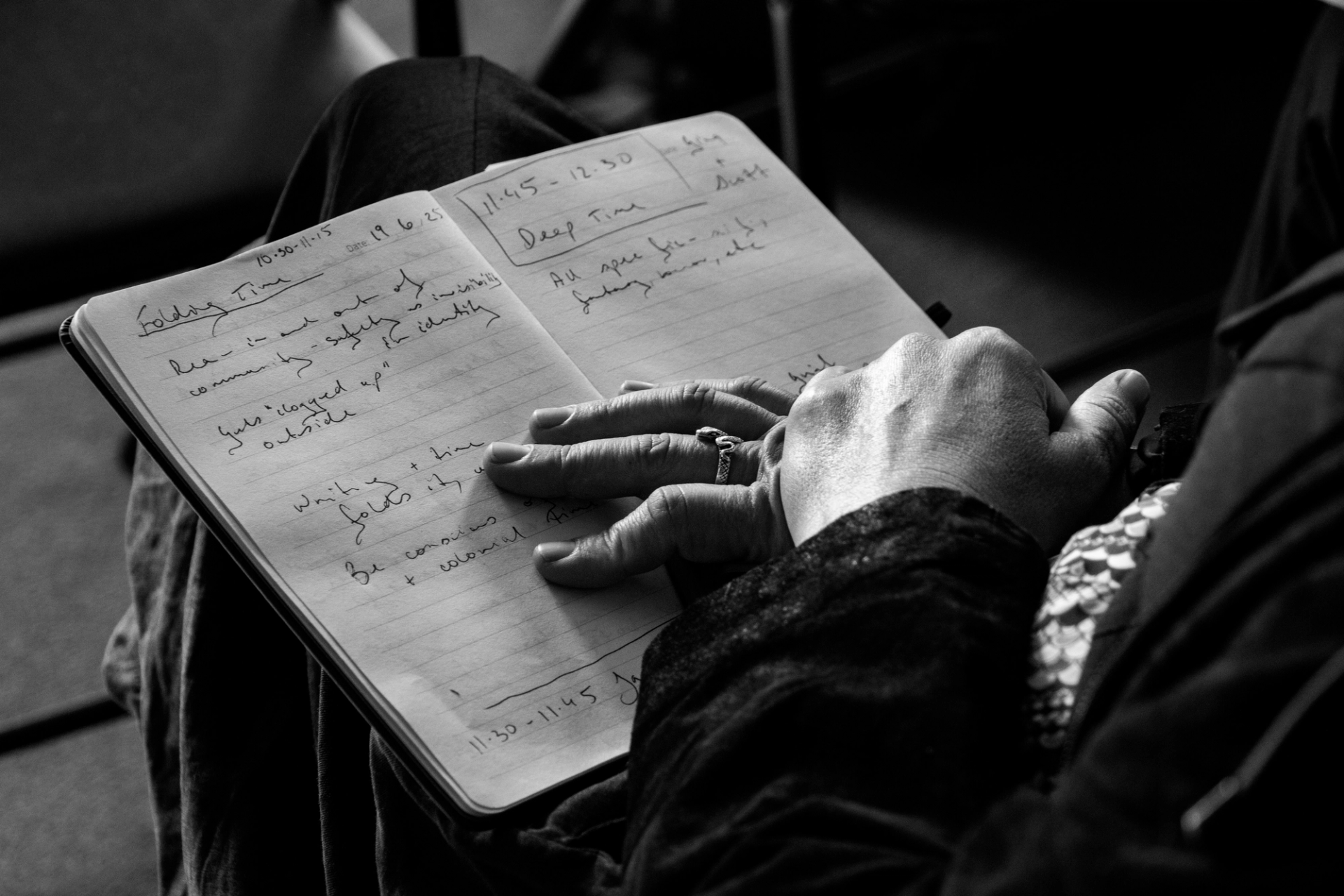 A person making notes in a notepad.