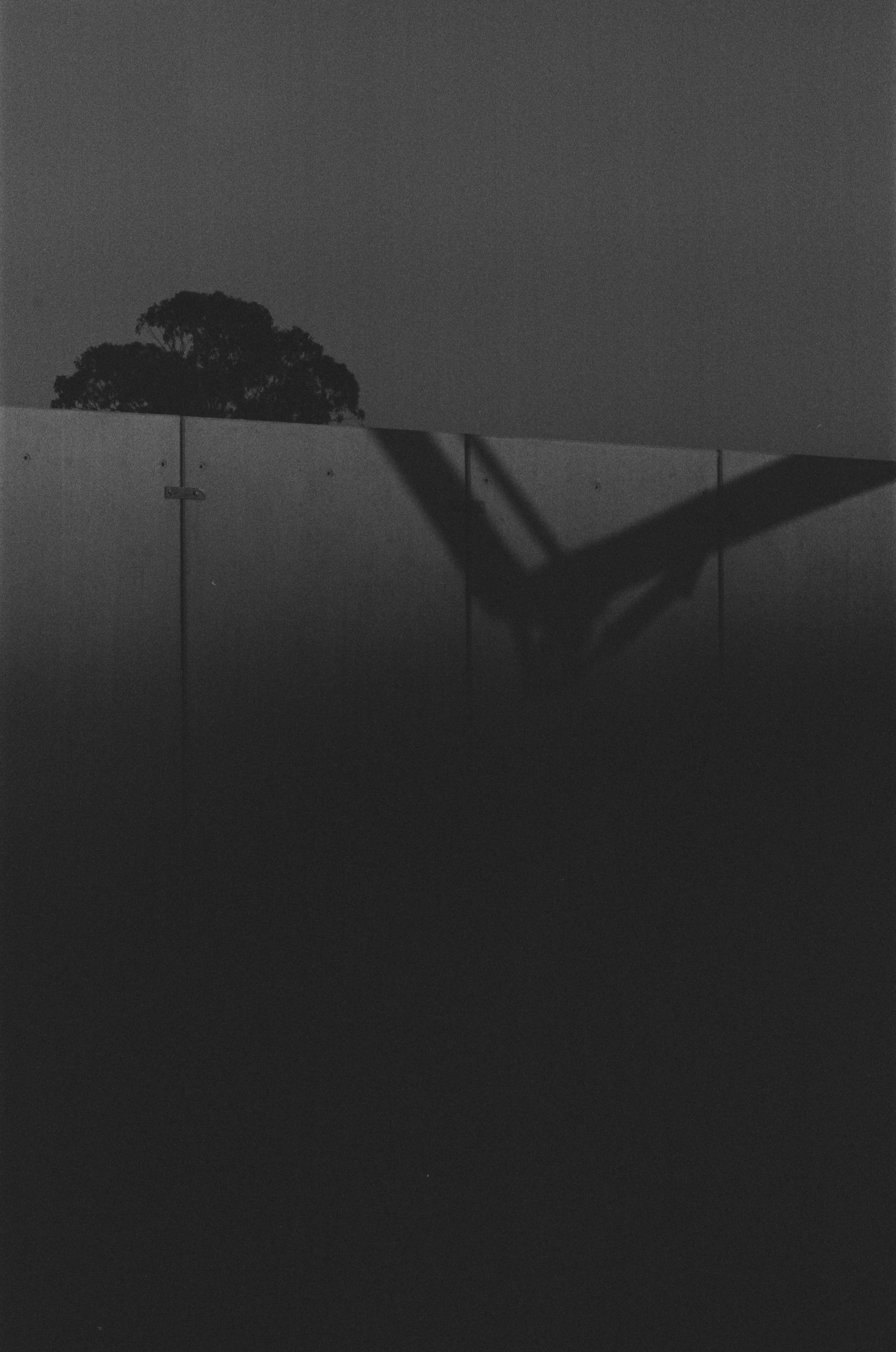 Crane shadow on a concrete wall.