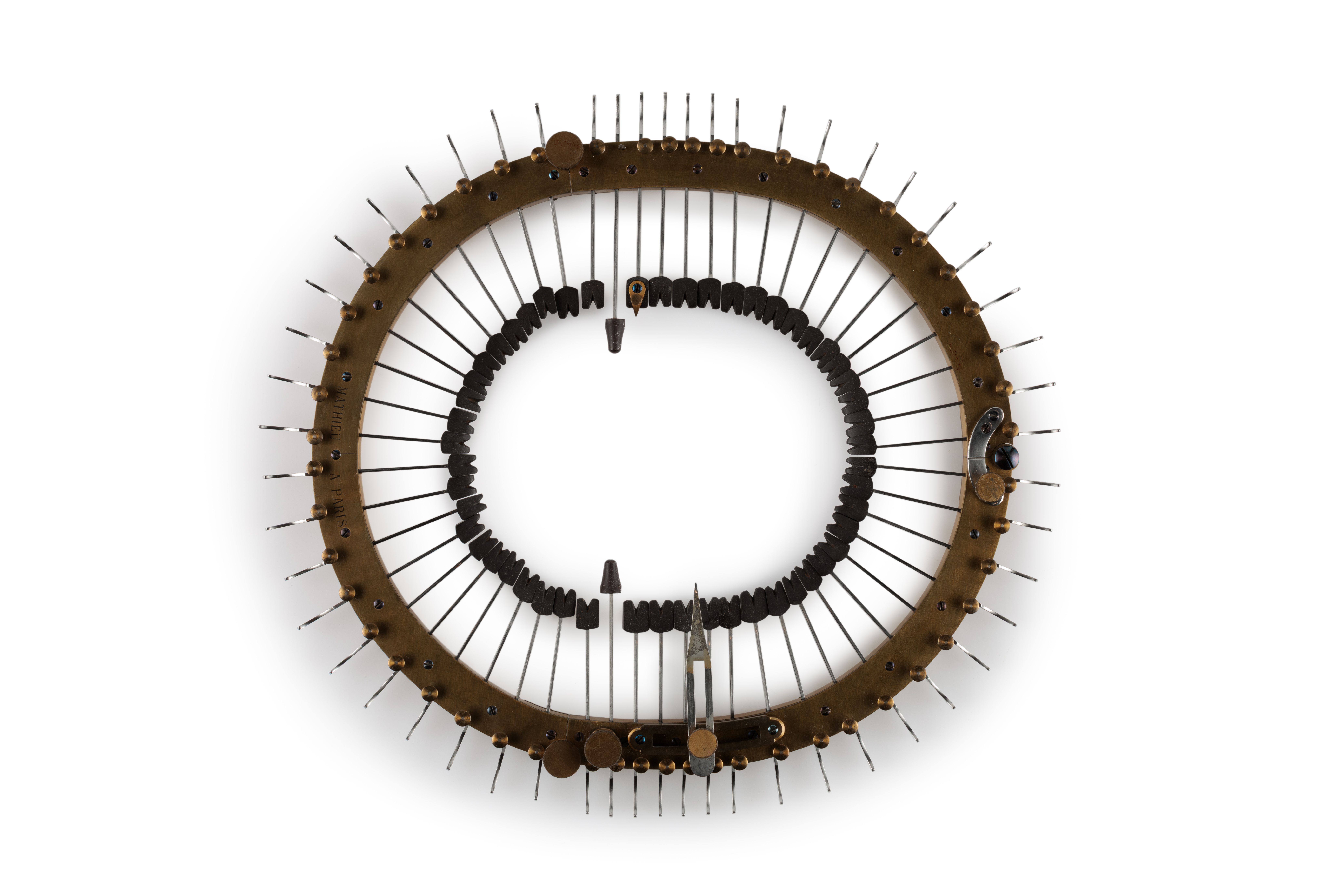 Oval brass frame holding 52 steel spokes (under tension) that are inserted through frame towards centre. The steel spokes have black rectangular ends with incised "V" and are tipped with a rigid natural latex known as gutta percha. They are adjusted by means of buttons to ratchet and spring. A component of the craniometer is a detachable steel strip that fits over the skull. There is also a lead pencil in a pencil holder with brass and metal attachment, and a nail with a brass head.