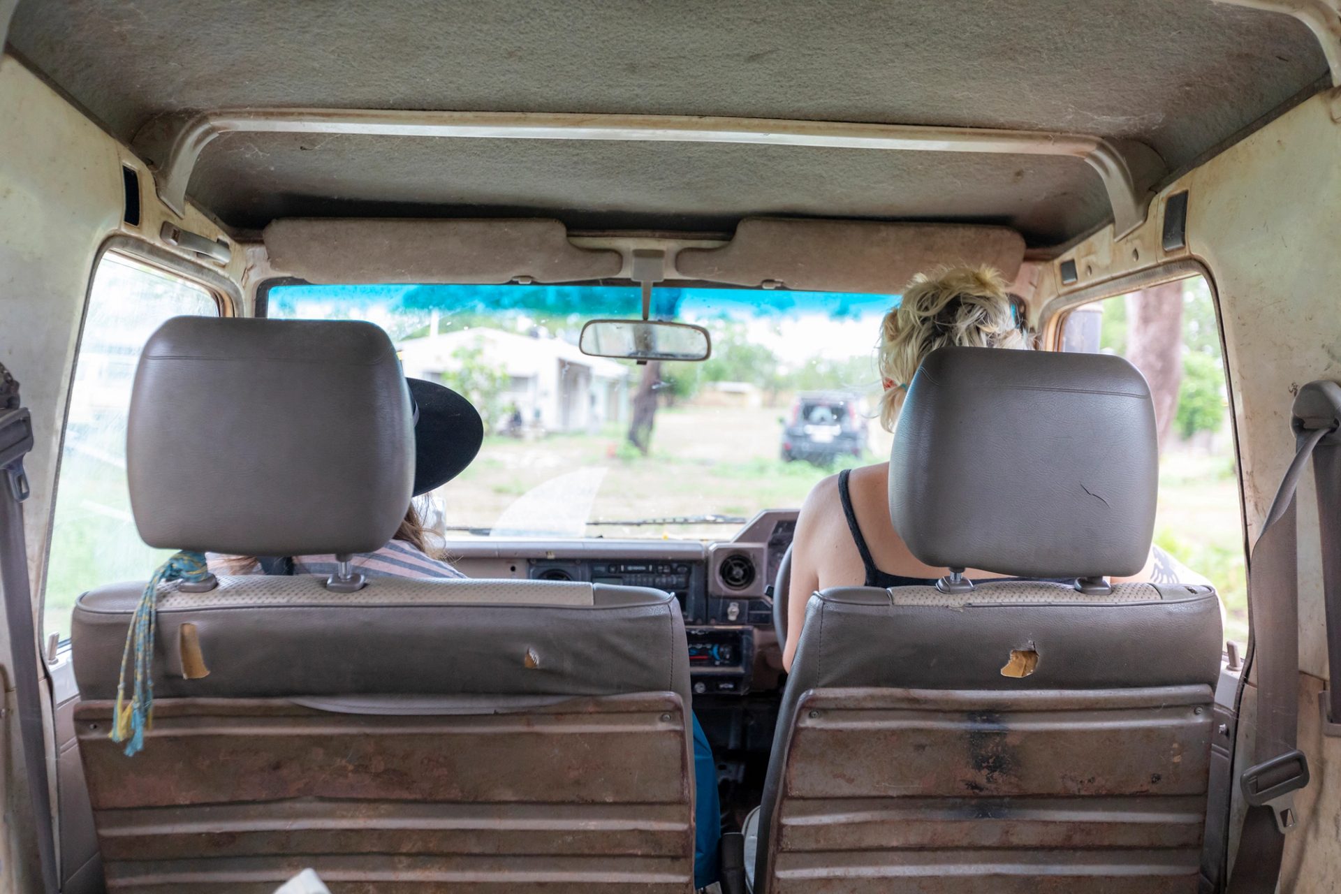 From inside the van you see two figures in the front.