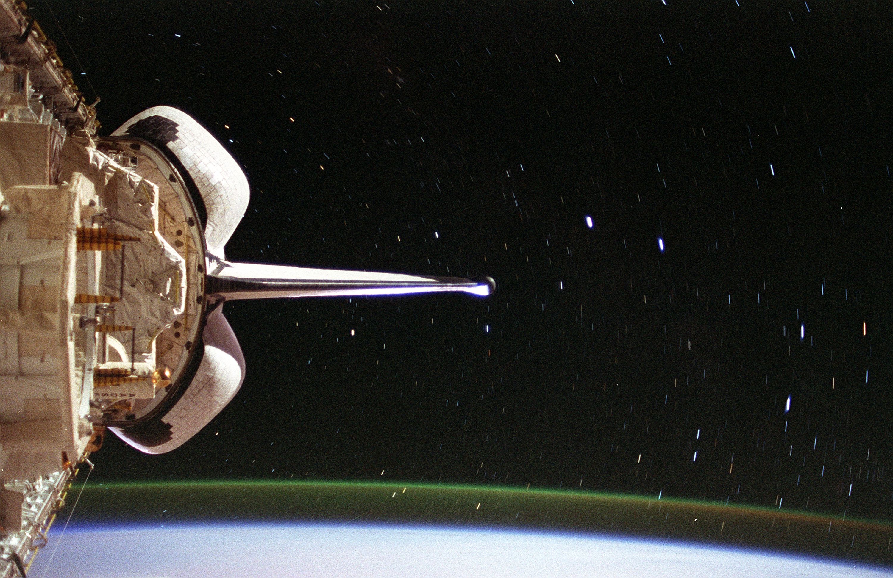 Photo of the space sky showing a view of Southern Cross, Alpha and Beta Centauri from a space shuttle. The space shuttle Columbia's vertical stabilizer appears to point to the four stars of the Southern Cross.