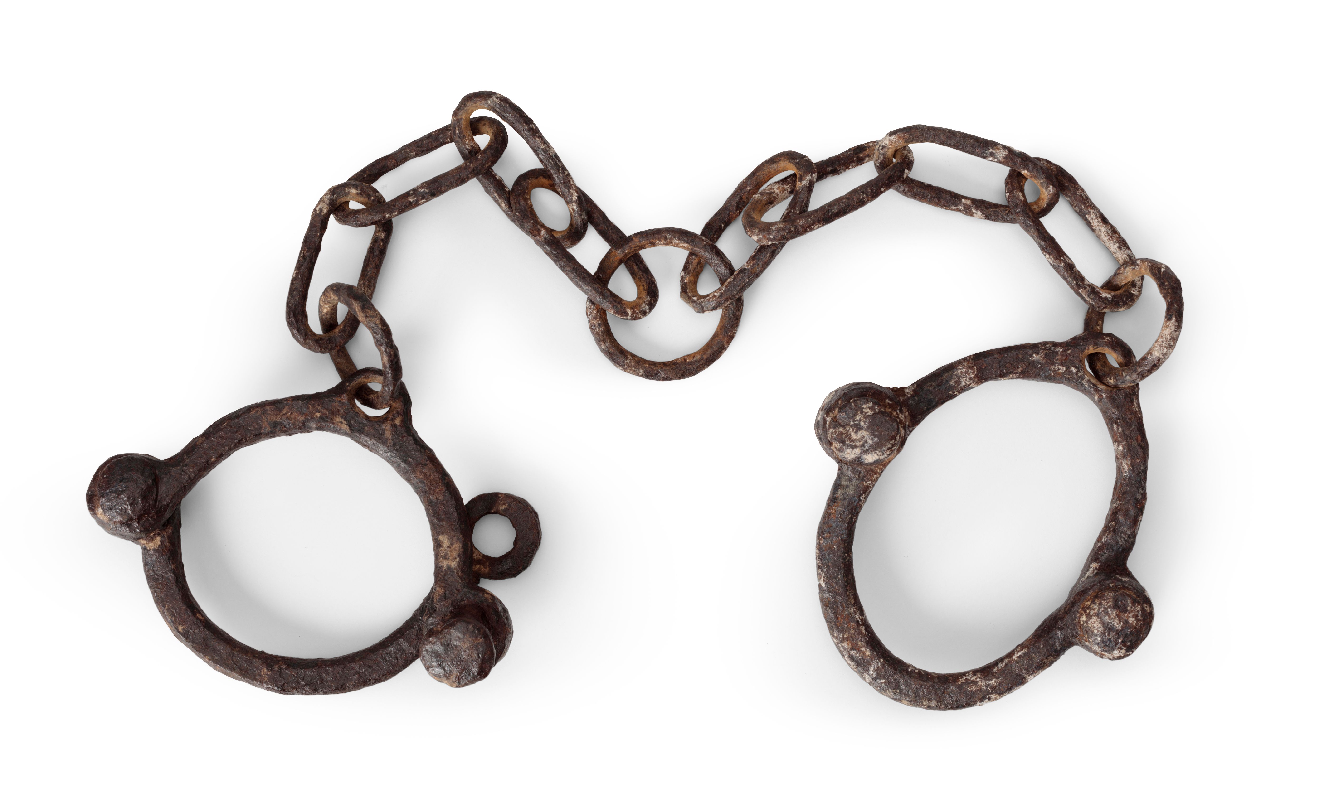 Leg manacles consisting of two iron, hinged circular rings, joined by a link chain. The chain consists of a round central link with four links and a smaller round link on each side joining to leg ring. The chain is attached to each leg ring through a hole in the ring.