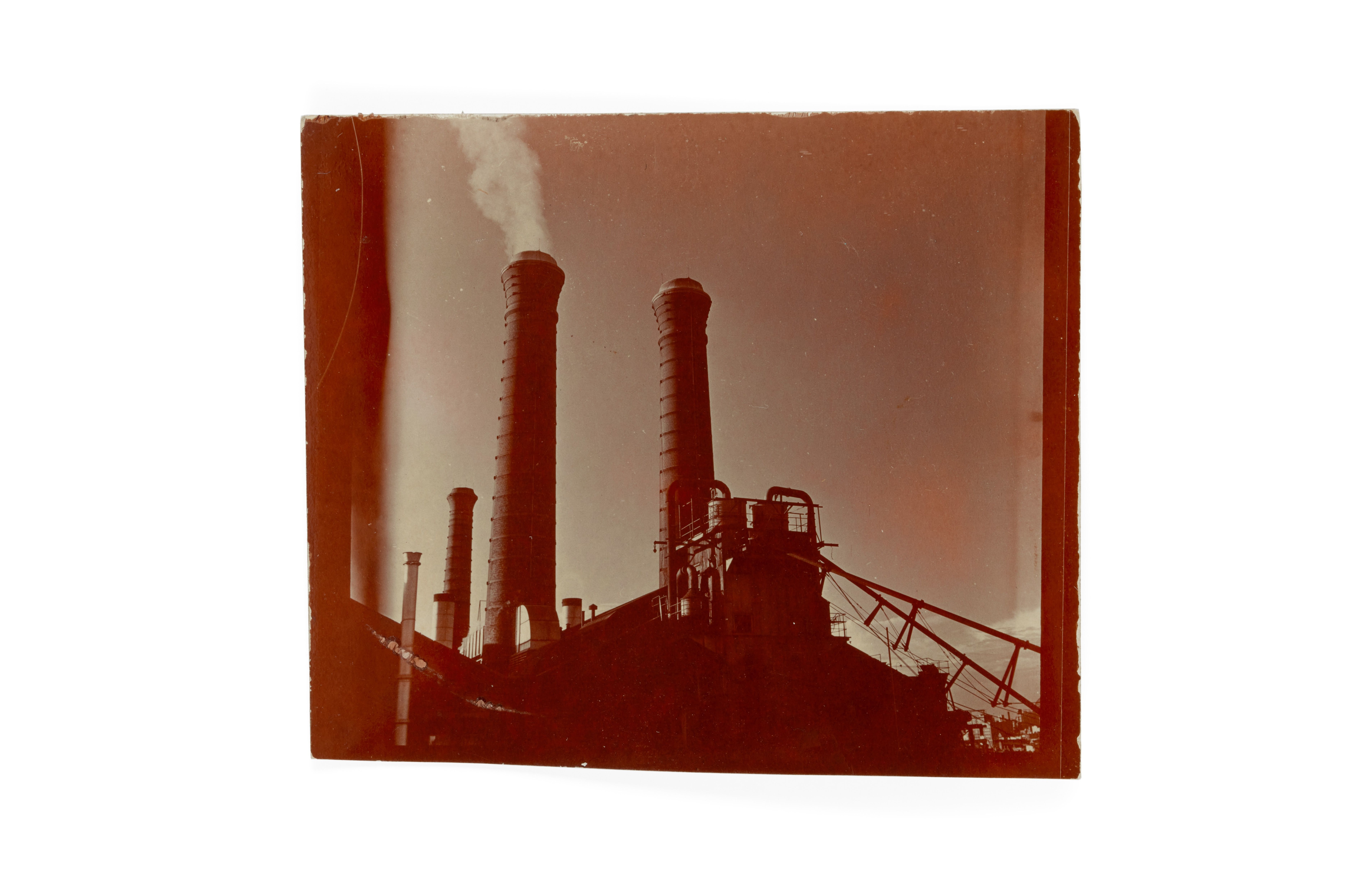 Photographic print of industrial scene, view of rear of Powerhouse depicting coal stack.