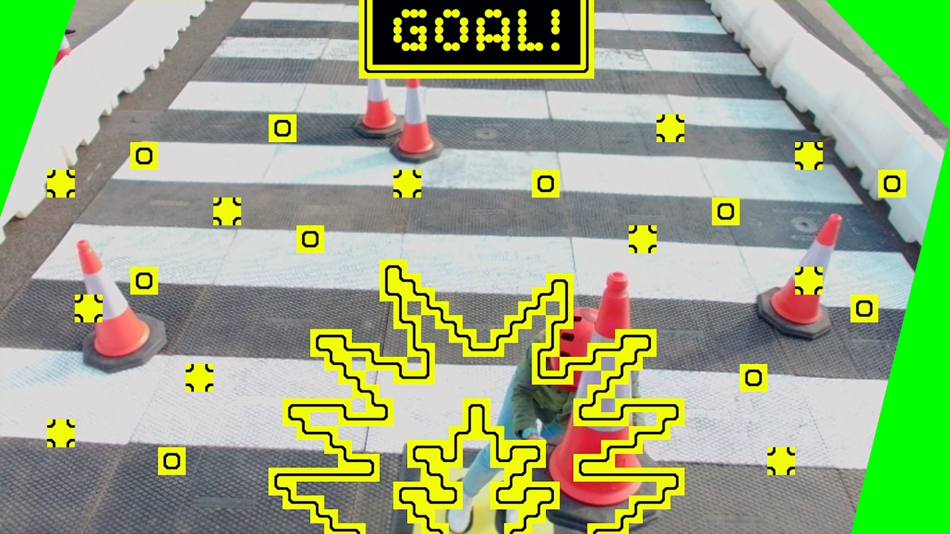 'GOAL!' text and smash iconography atop a photo of a witches cones and pedestrian crossing.