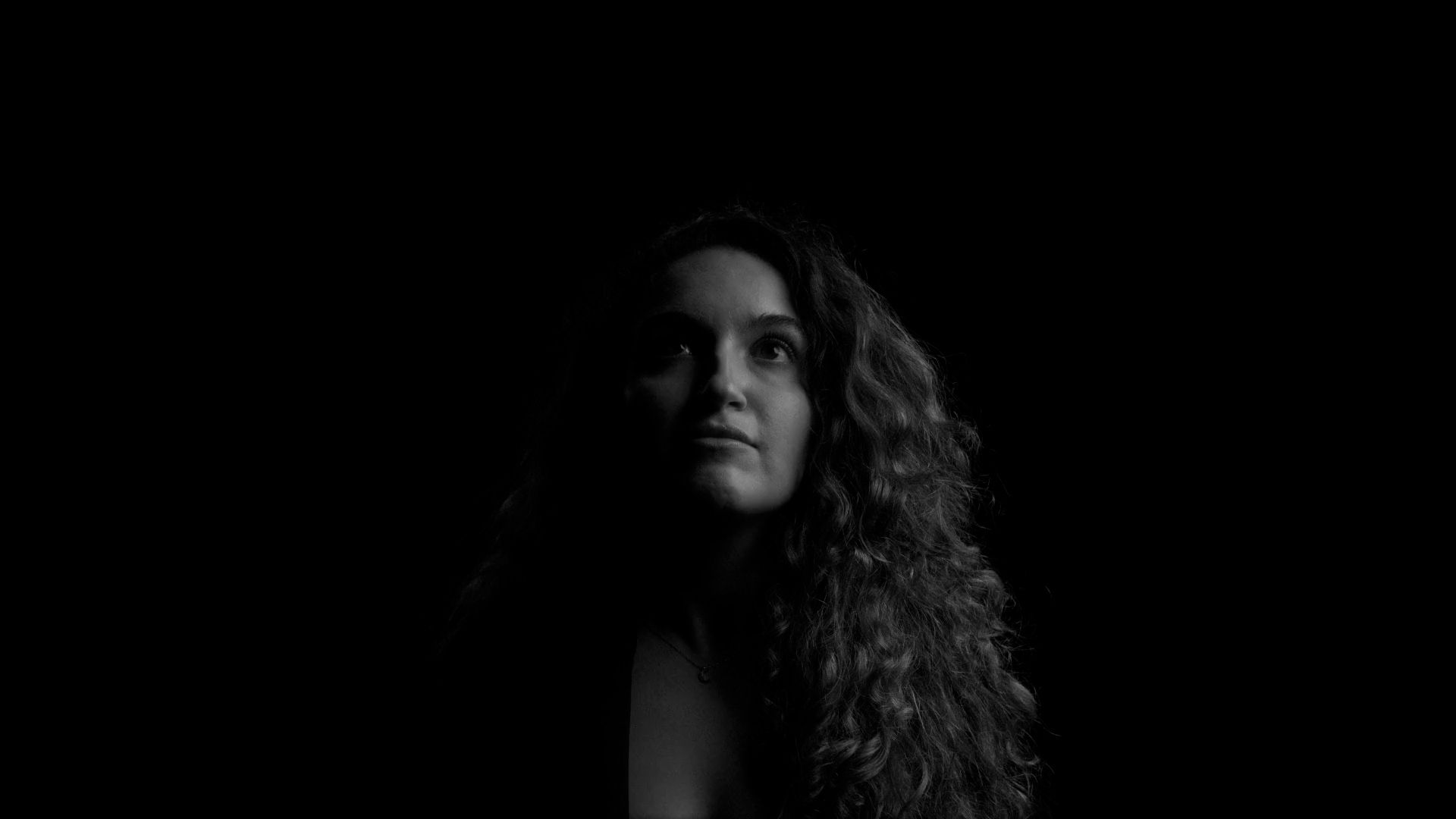 Half lit face of a woman.