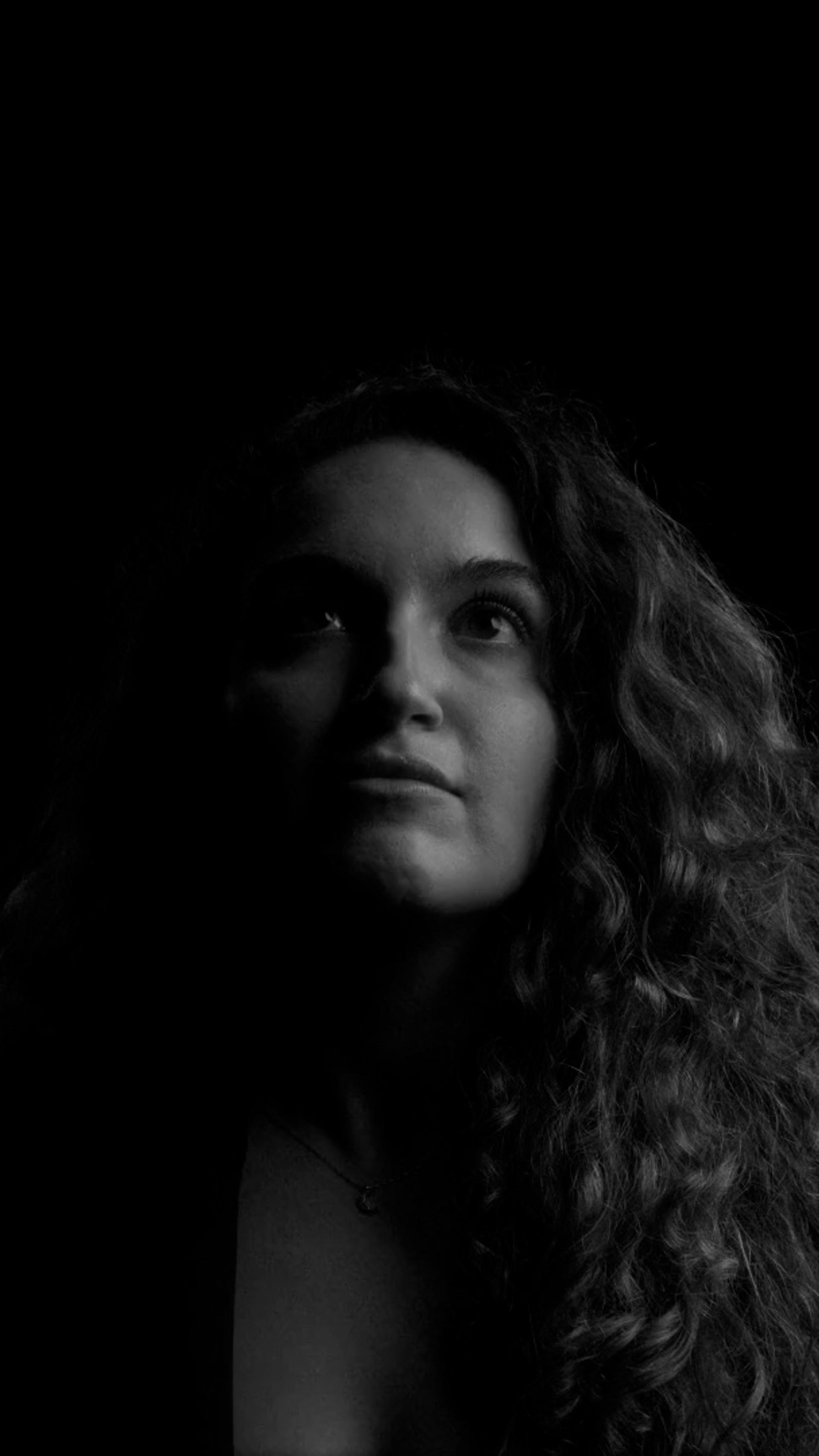 Half lit face of a woman.