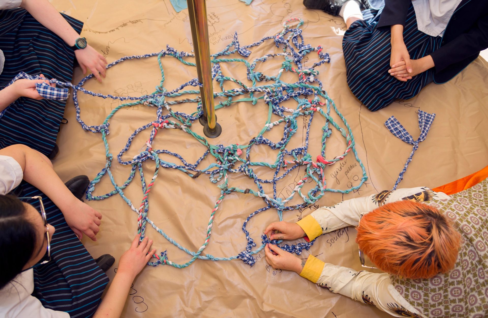school kids sitting around a fabric workshop