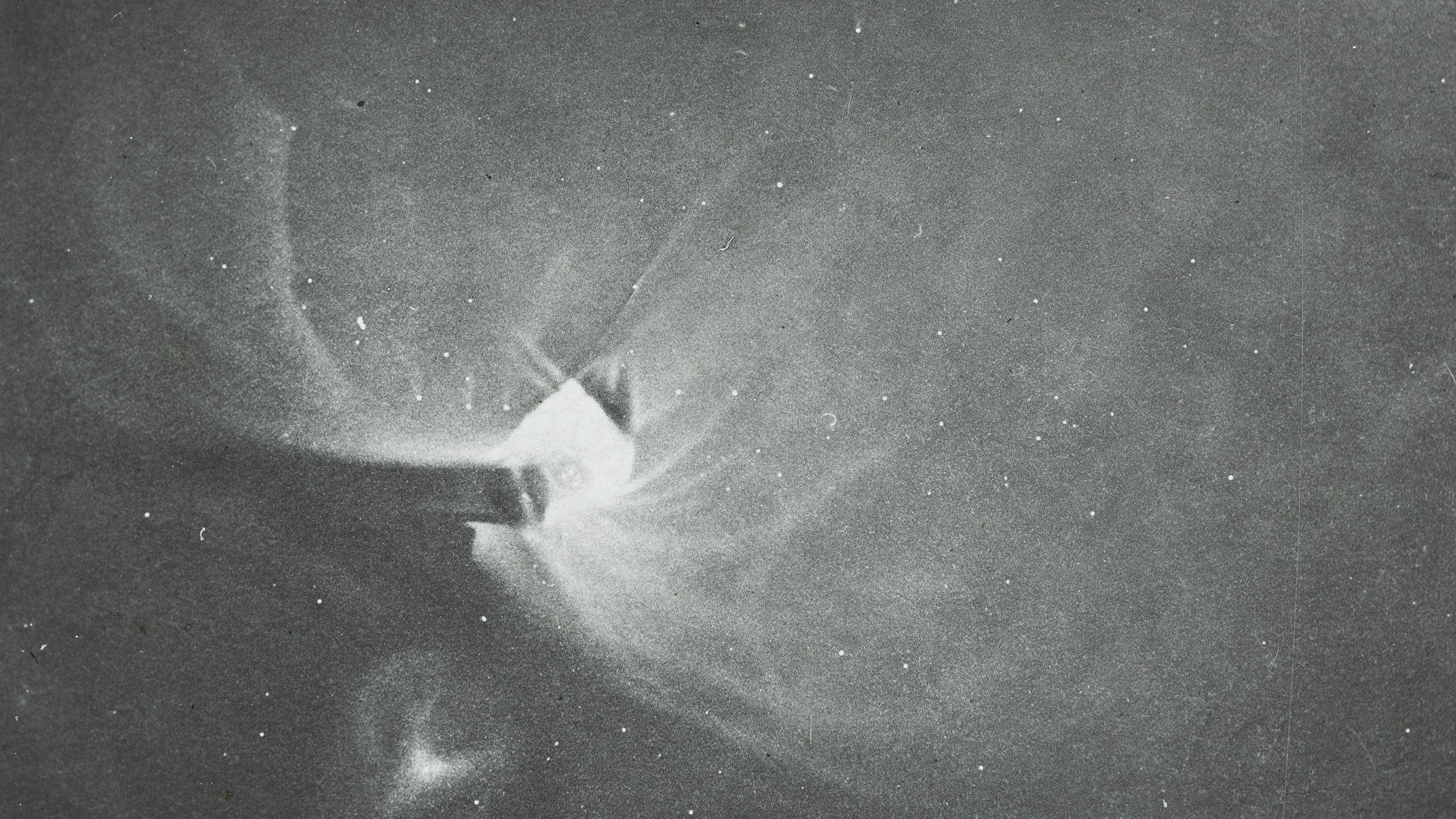 Photograph of a lantern slide depicting a black and white drawing of Orion made of glass and paper.