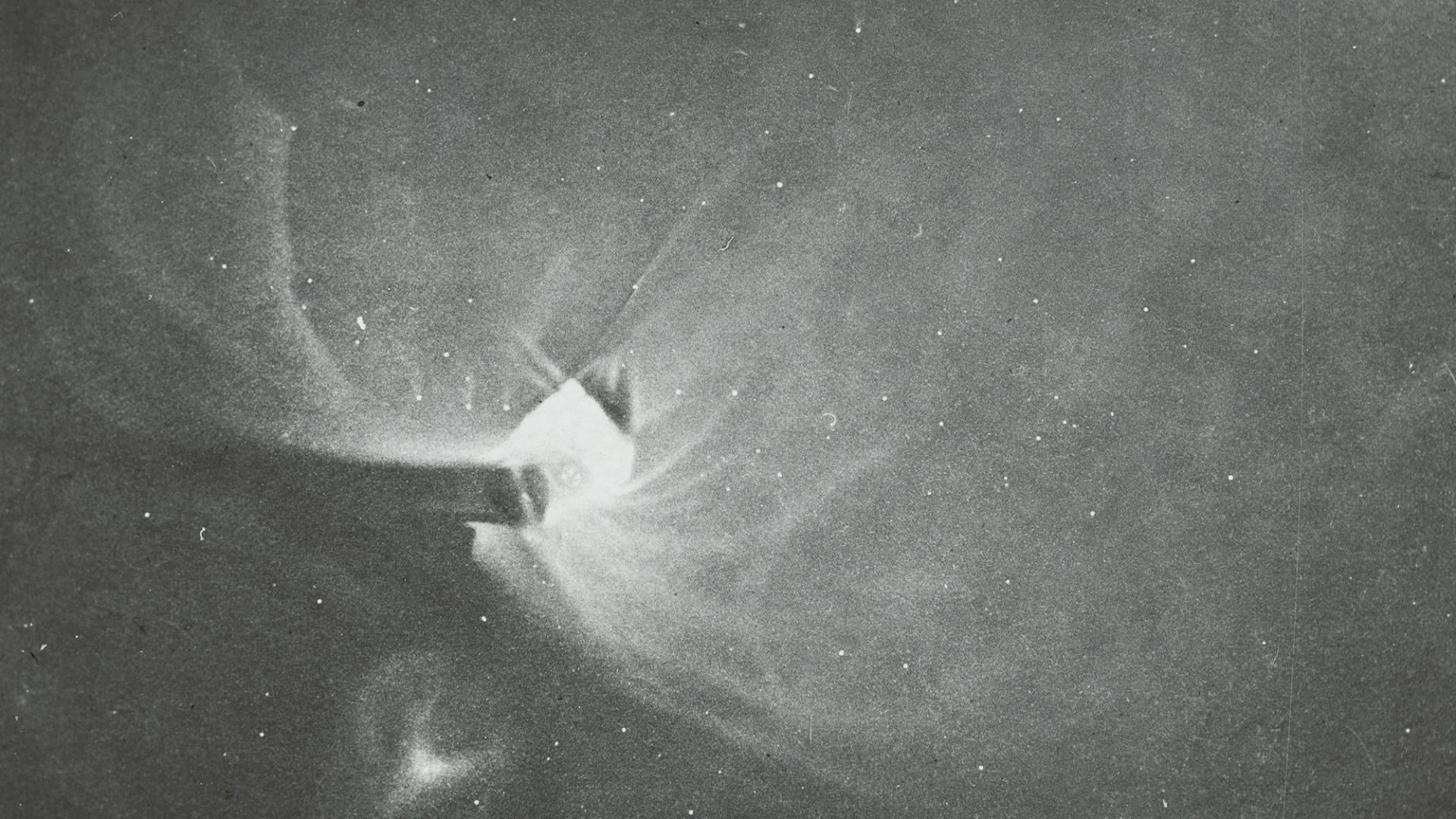 Photograph of a lantern slide depicting a black and white drawing of Orion made of glass and paper.