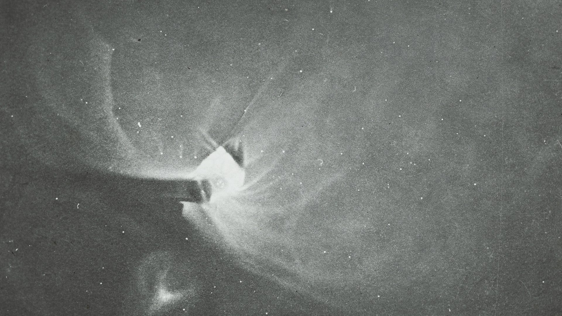 Photograph of a lantern slide depicting a black and white drawing of Orion made of glass and paper.