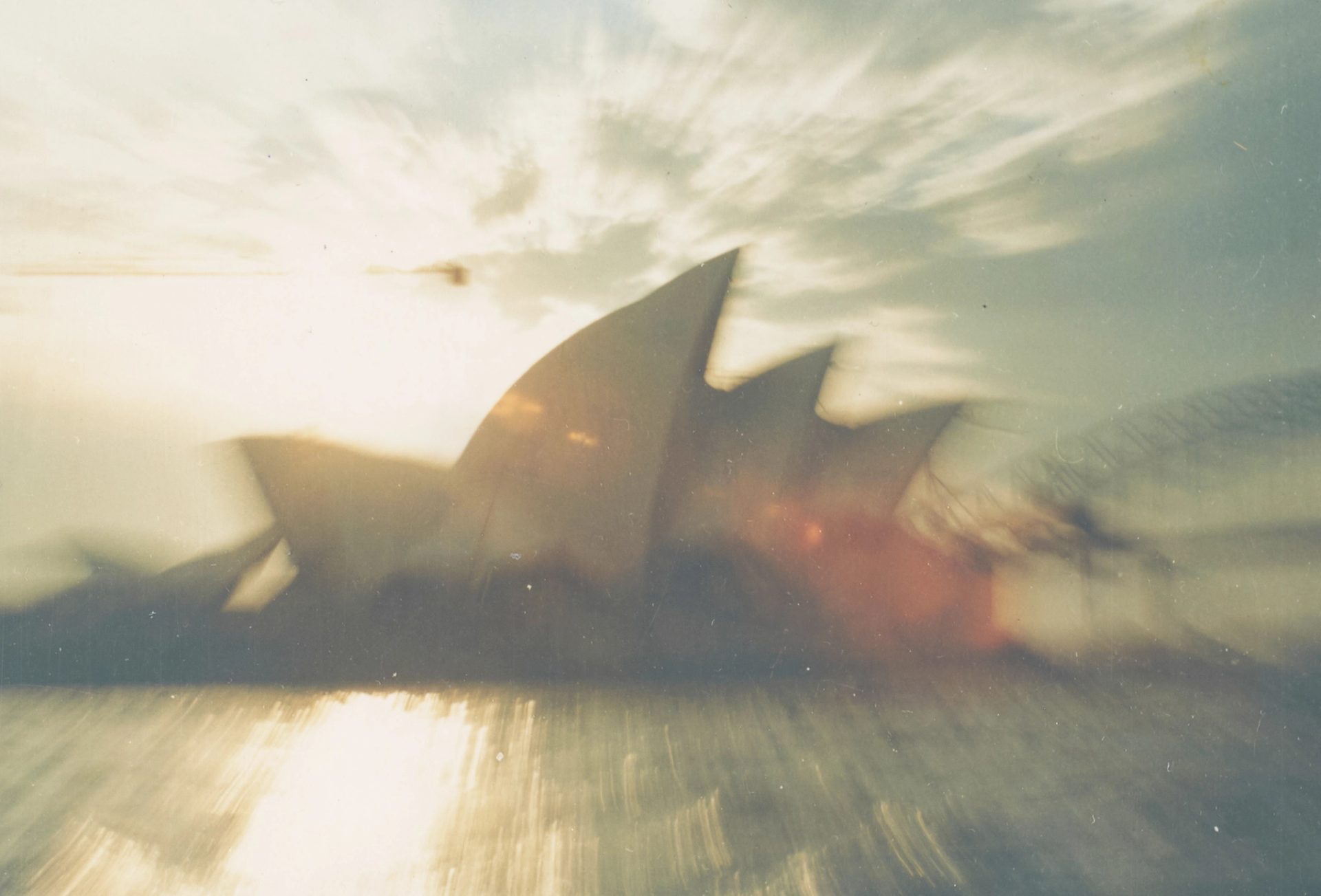 Photograph of Sydney Opera Hous with sun beams