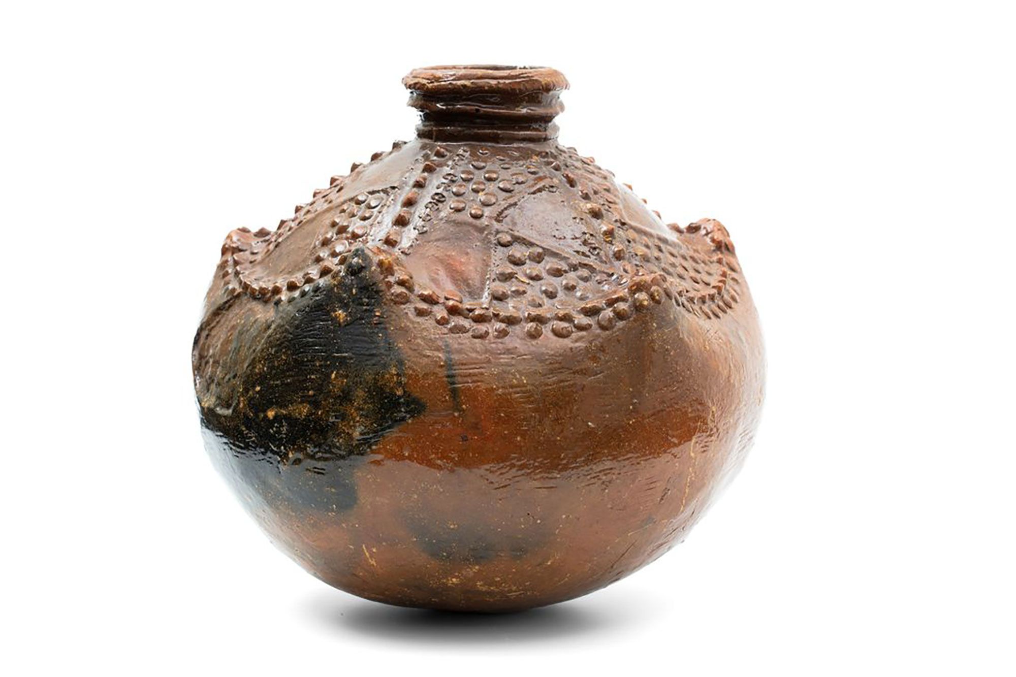 A dark brown round water vessel made of clay.