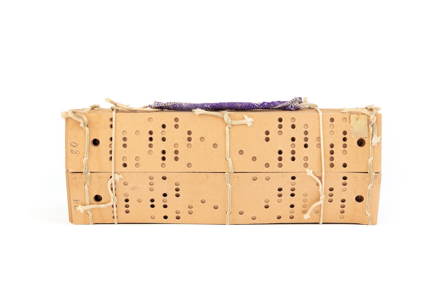 Stack of punch cards bound by string.
