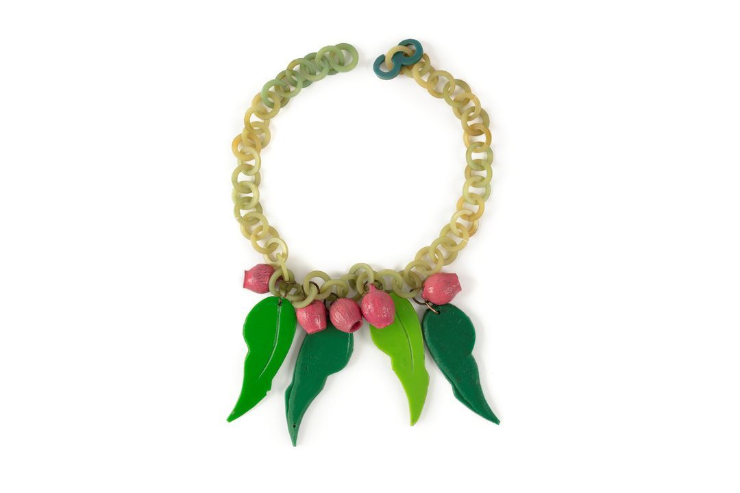 Necklace made up of green plastic round links from which hang by small metal rings