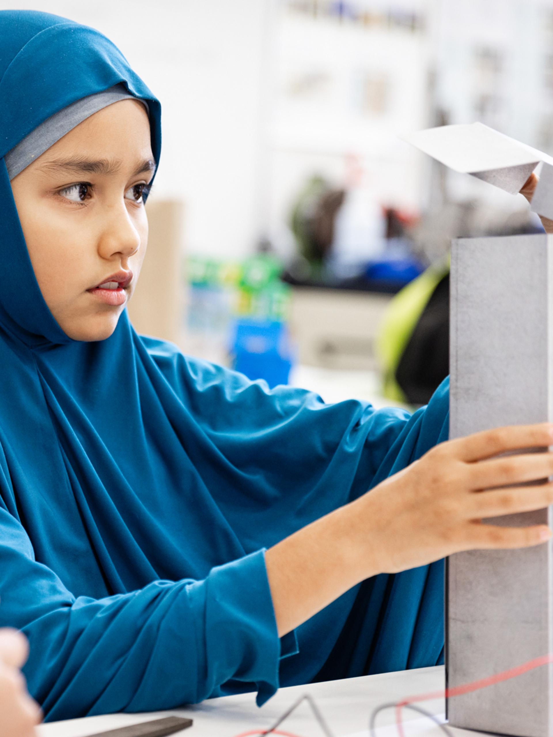 Young figure is building a device.