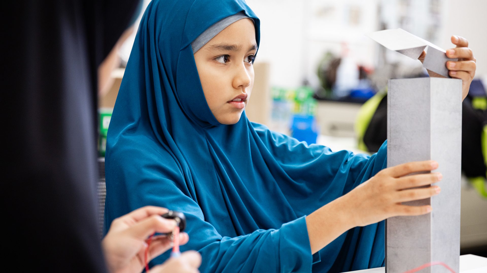 Young figure is building a device.