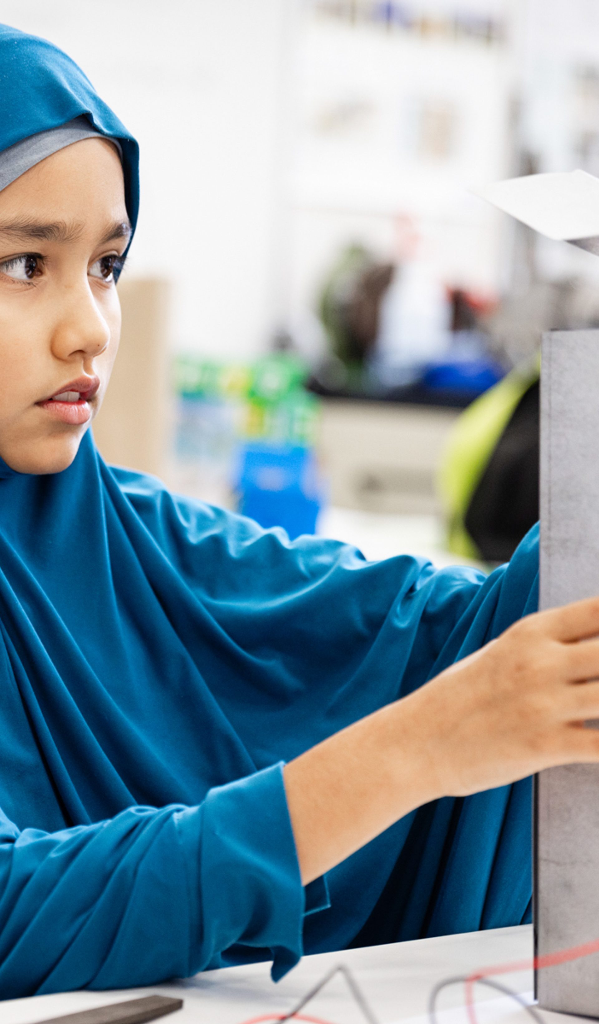 Young figure is building a device.