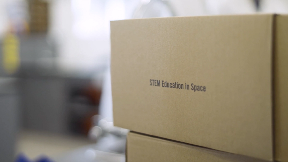 A brown box reading ‘STEM Education in Space’