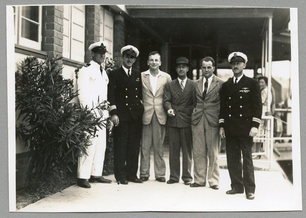 Men from 1941 standing facing the camera, some wearing uniforms