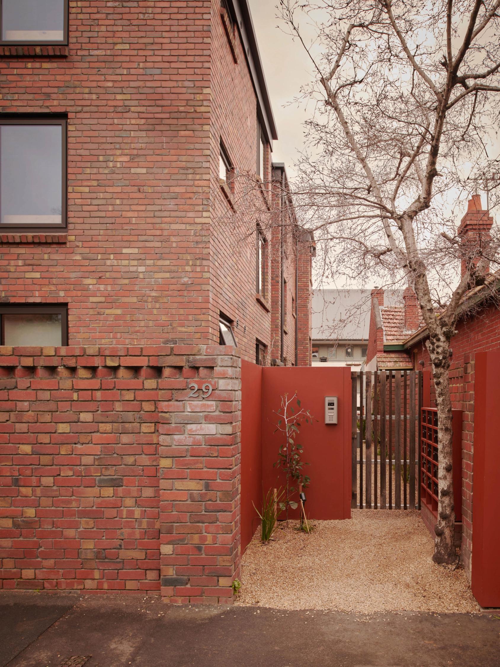 Gate and outdoor entrance down the side of an apartment.