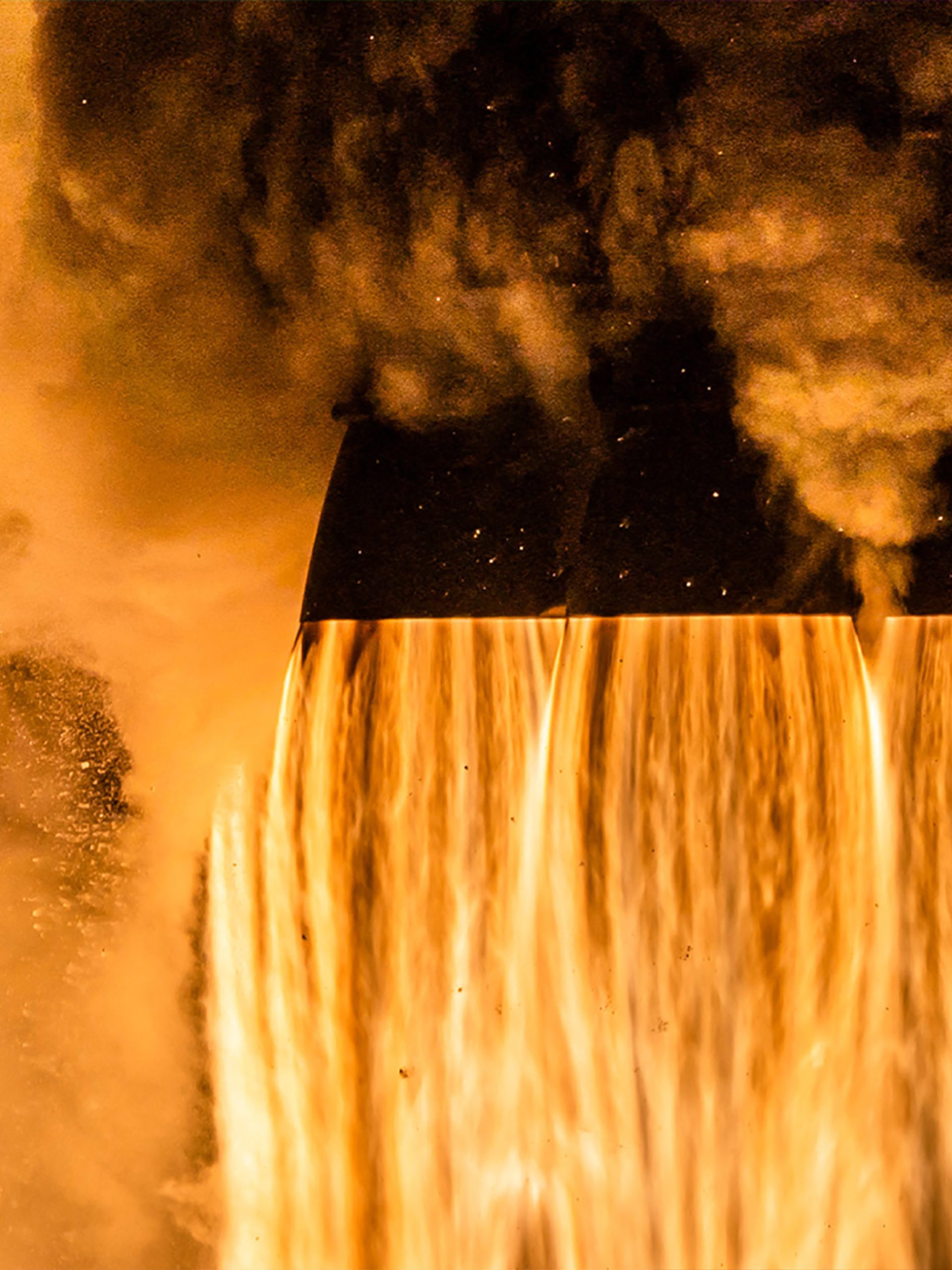 Close up of the bottom of the Crew-4 spacecraft launching, fire and smoke coming out of the 4 cone shaped exhausts and filling the image.