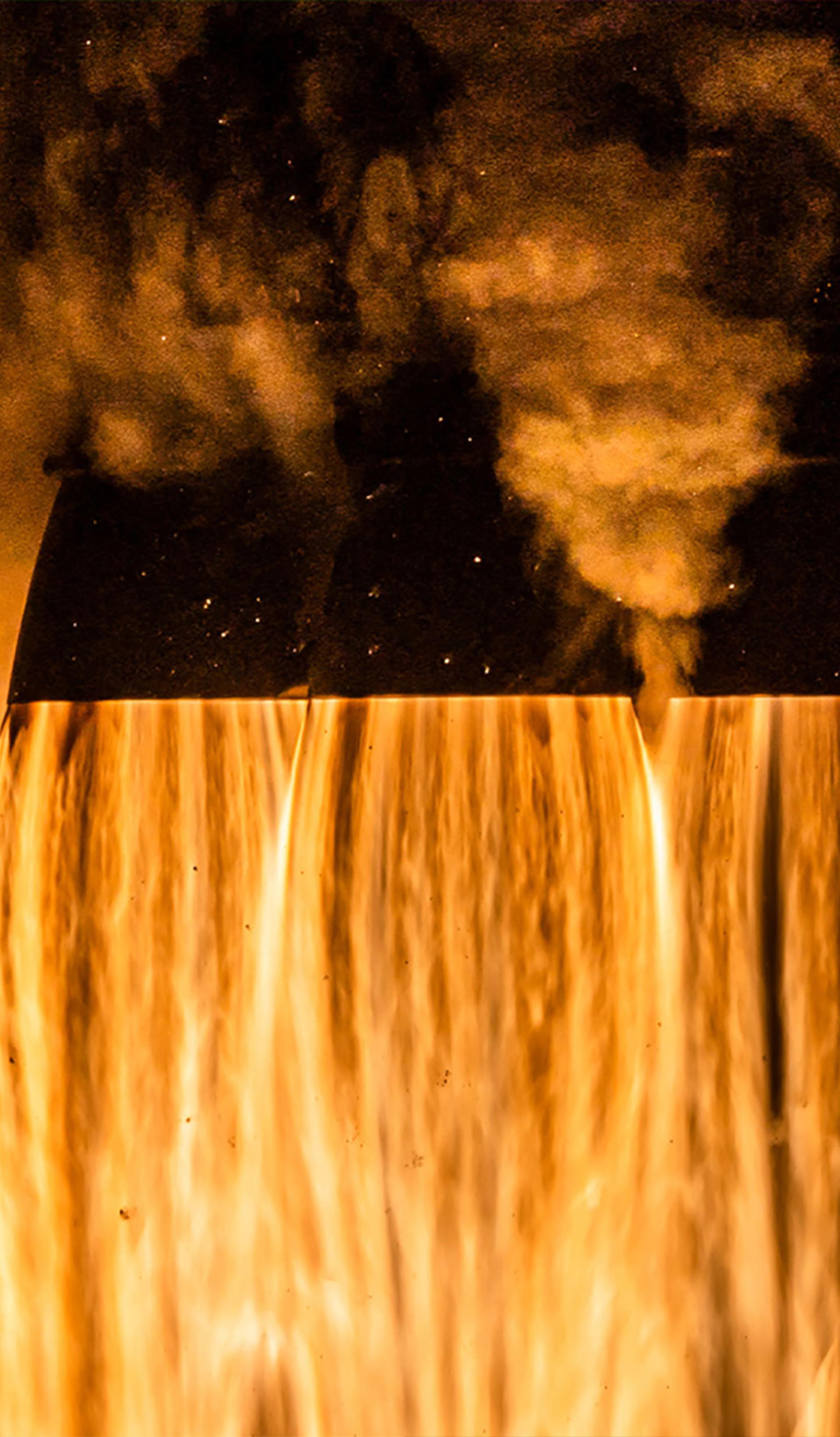 Close up of the bottom of the Crew-4 spacecraft launching, fire and smoke coming out of the 4 cone shaped exhausts and filling the image.
