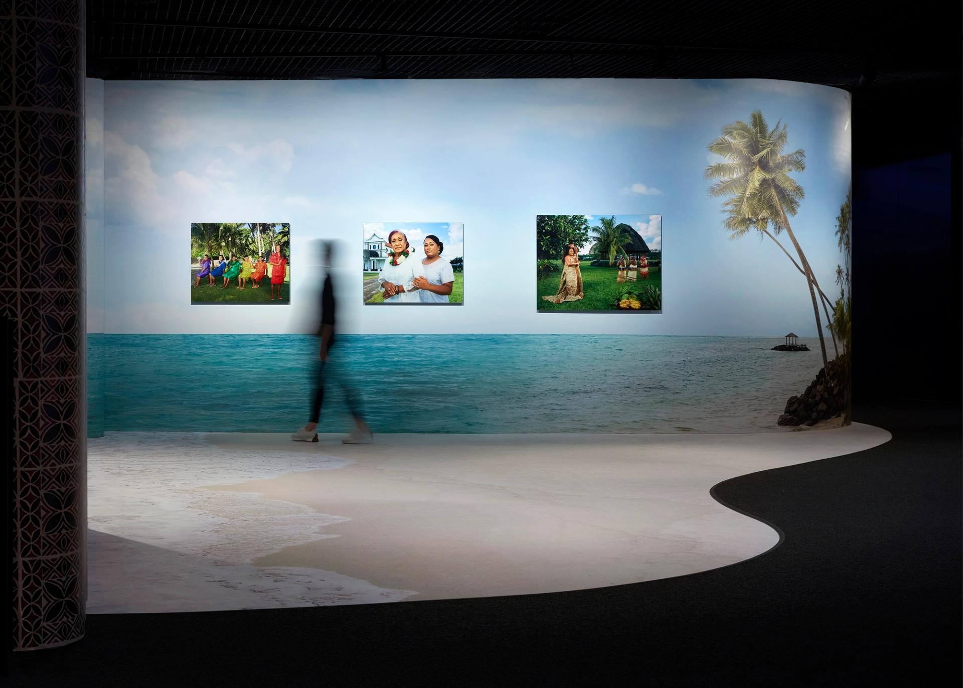 A person walking through an exhibition space.