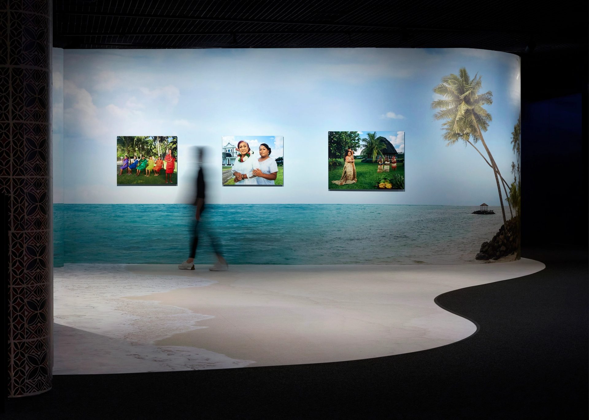 A person walking through an exhibition space.