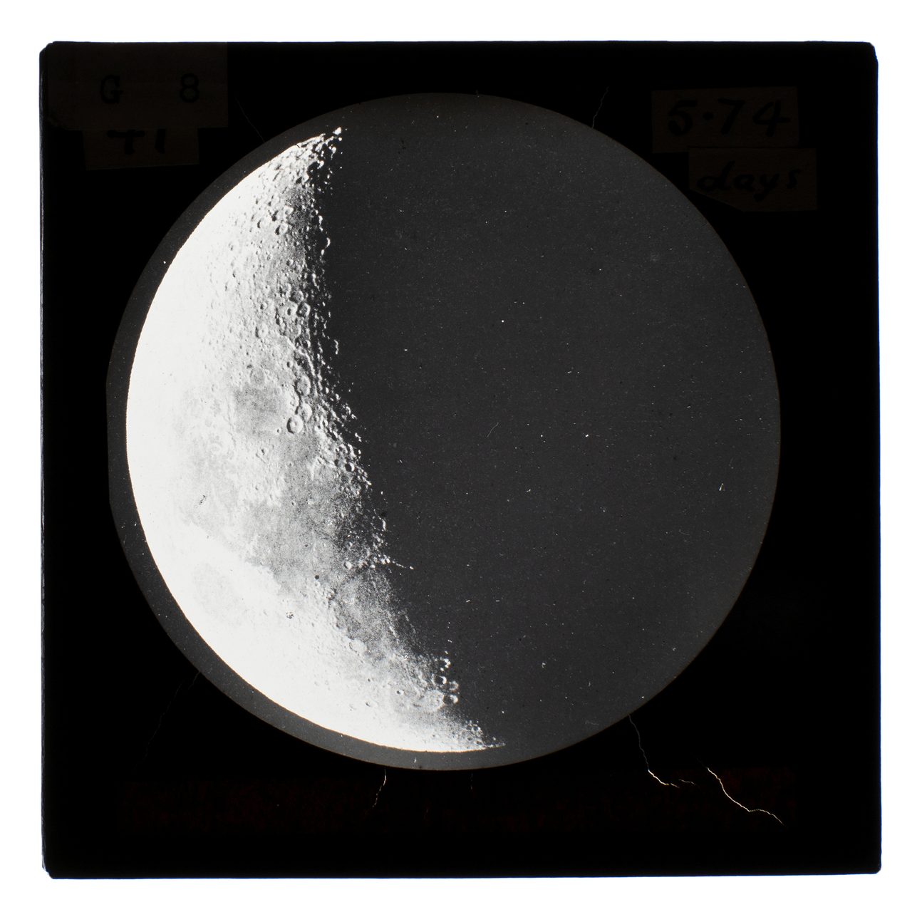 A lantern slide photograph of the moon covered in 60% shadow