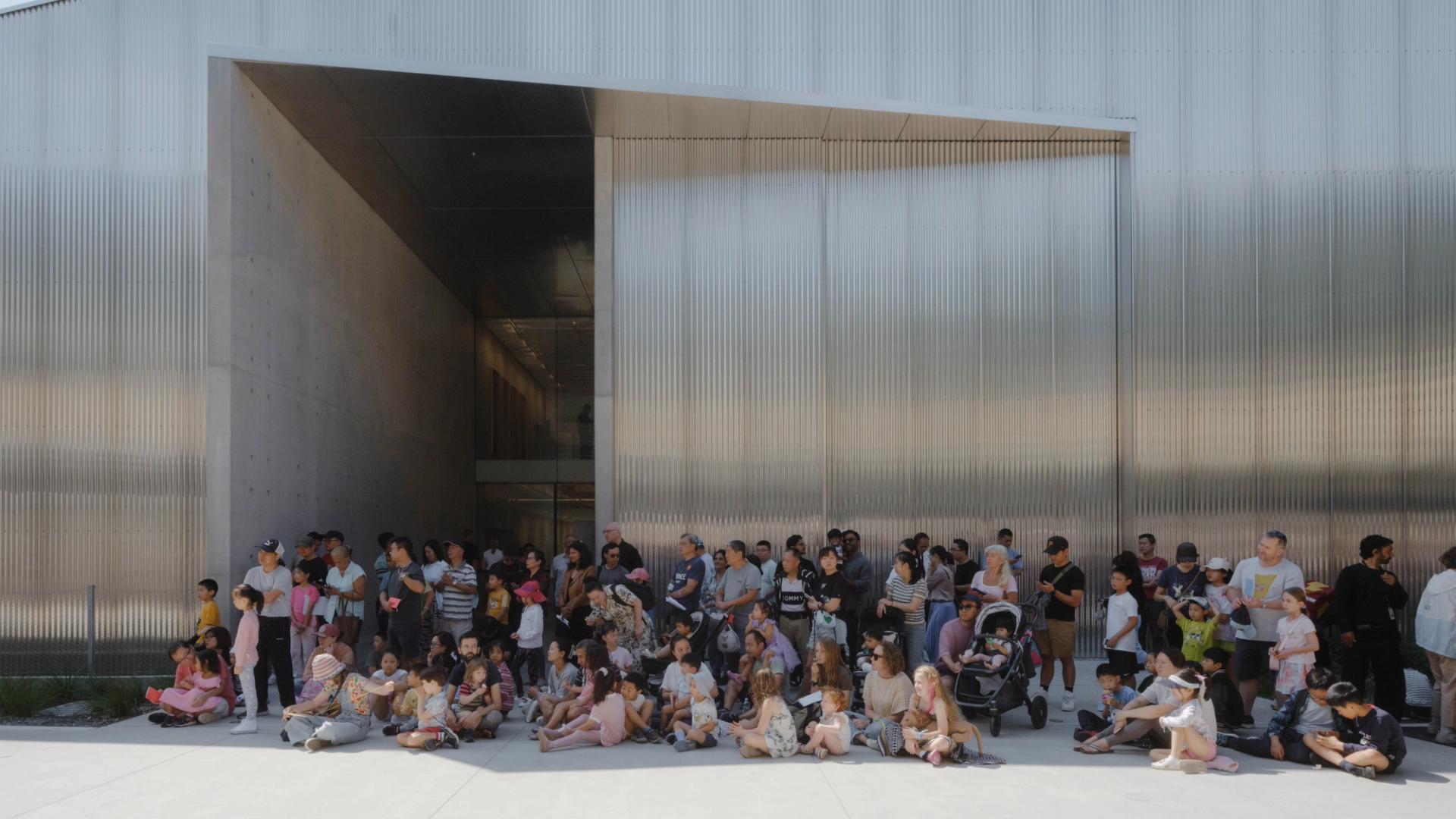People waiting outside a building.