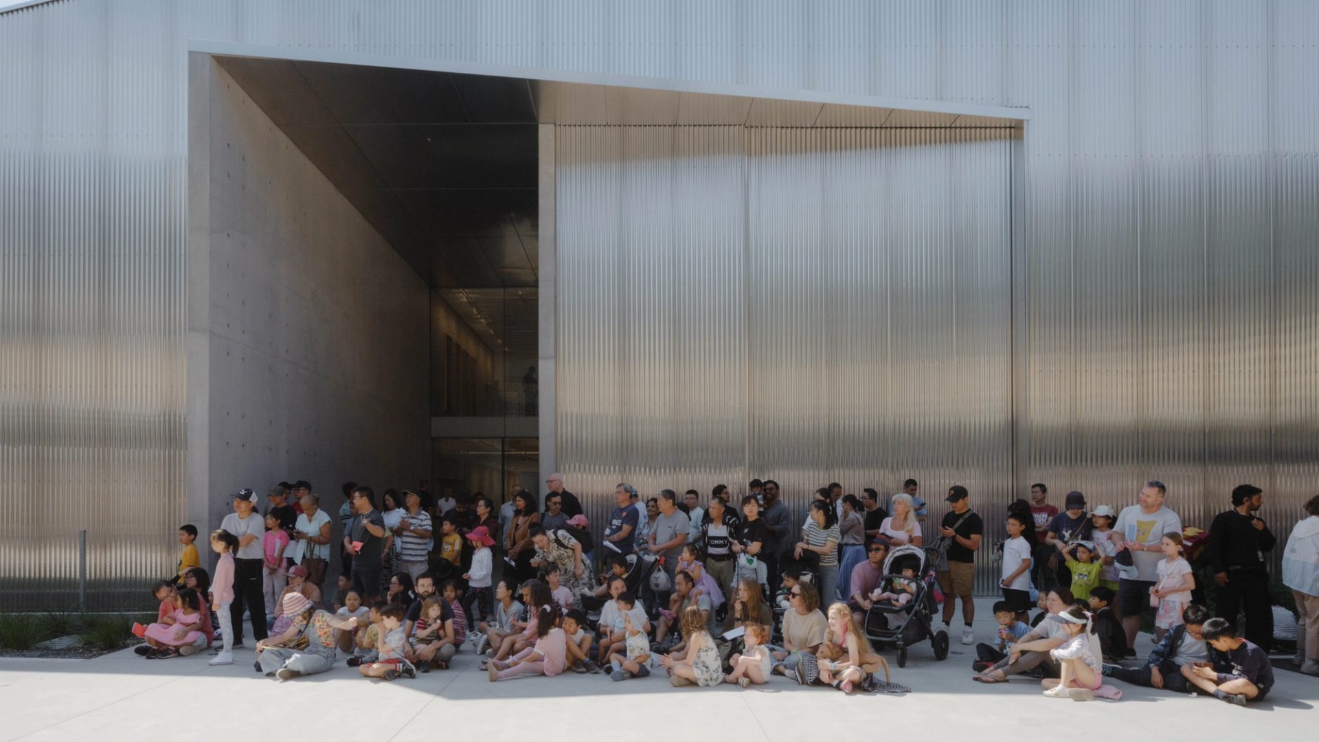 People waiting outside a building.