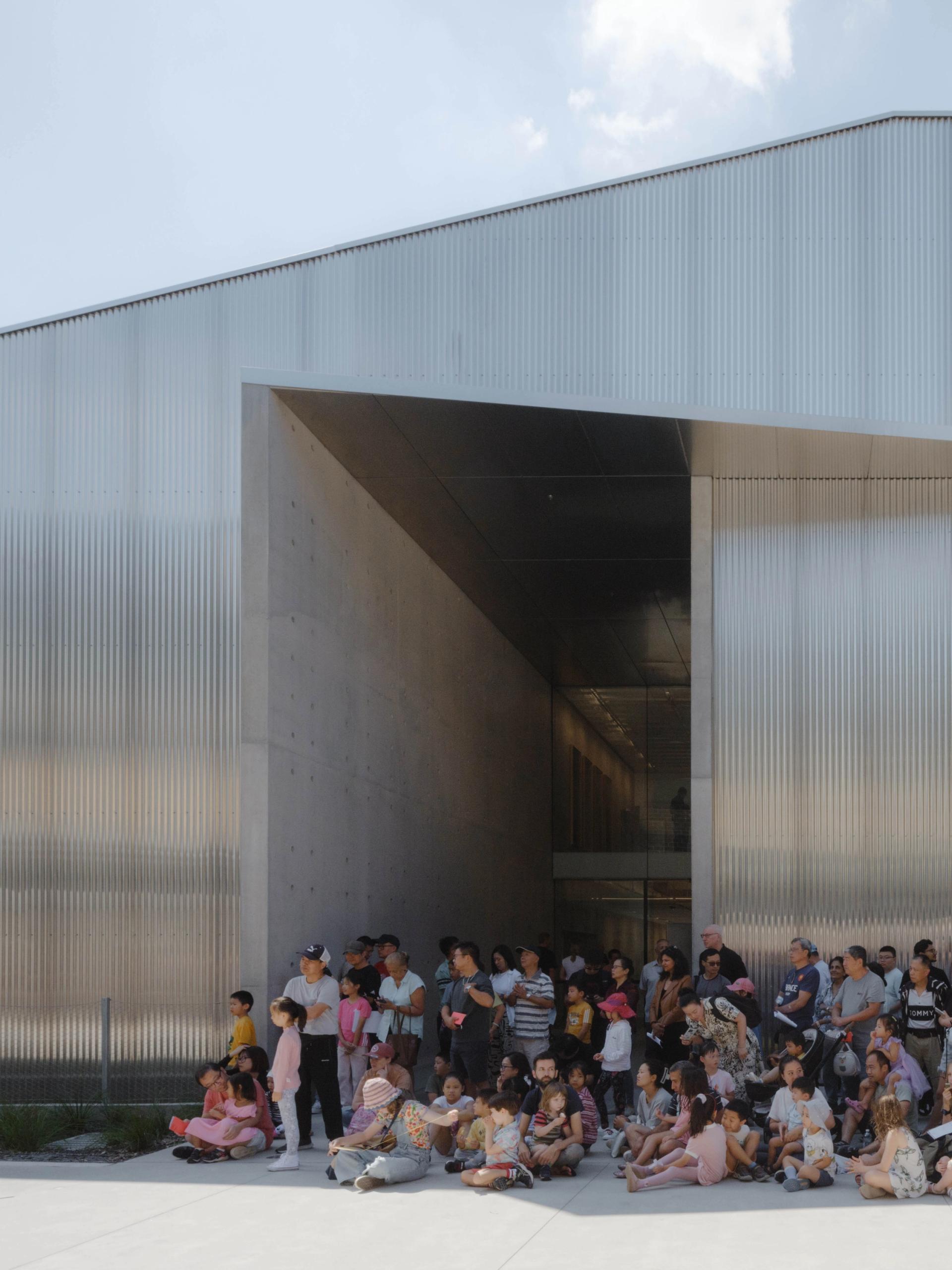 People waiting outside a building.