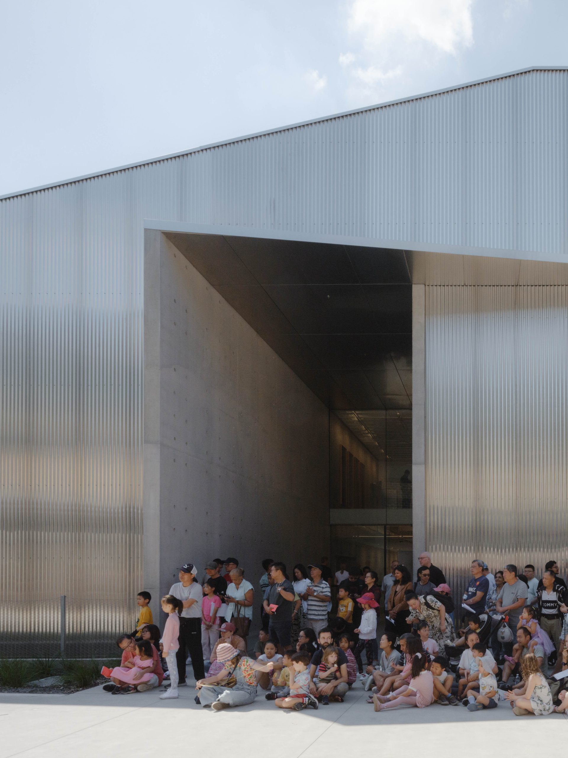 People waiting outside a building.