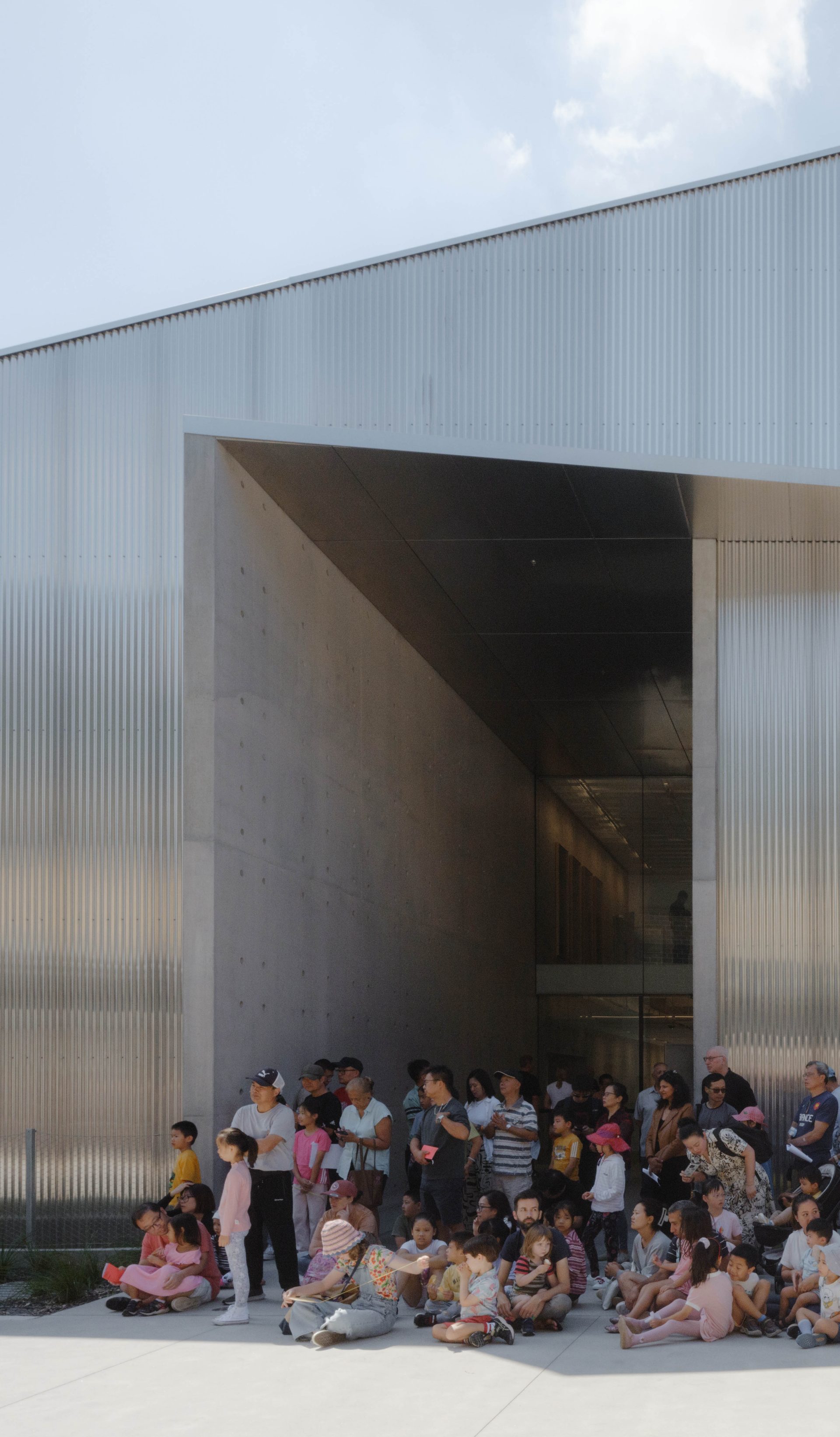 People waiting outside a building.