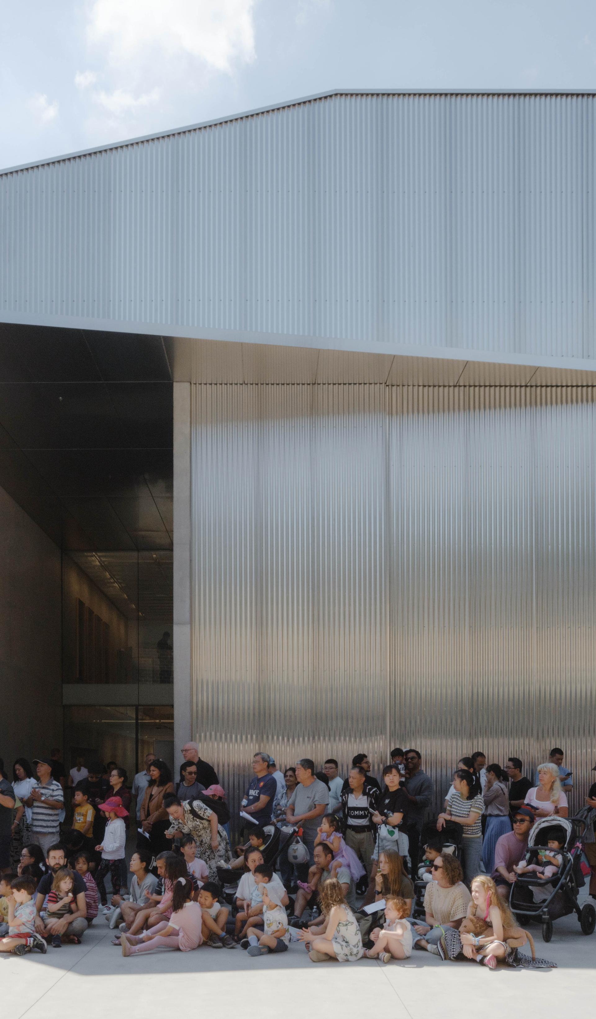 People waiting outside a building.