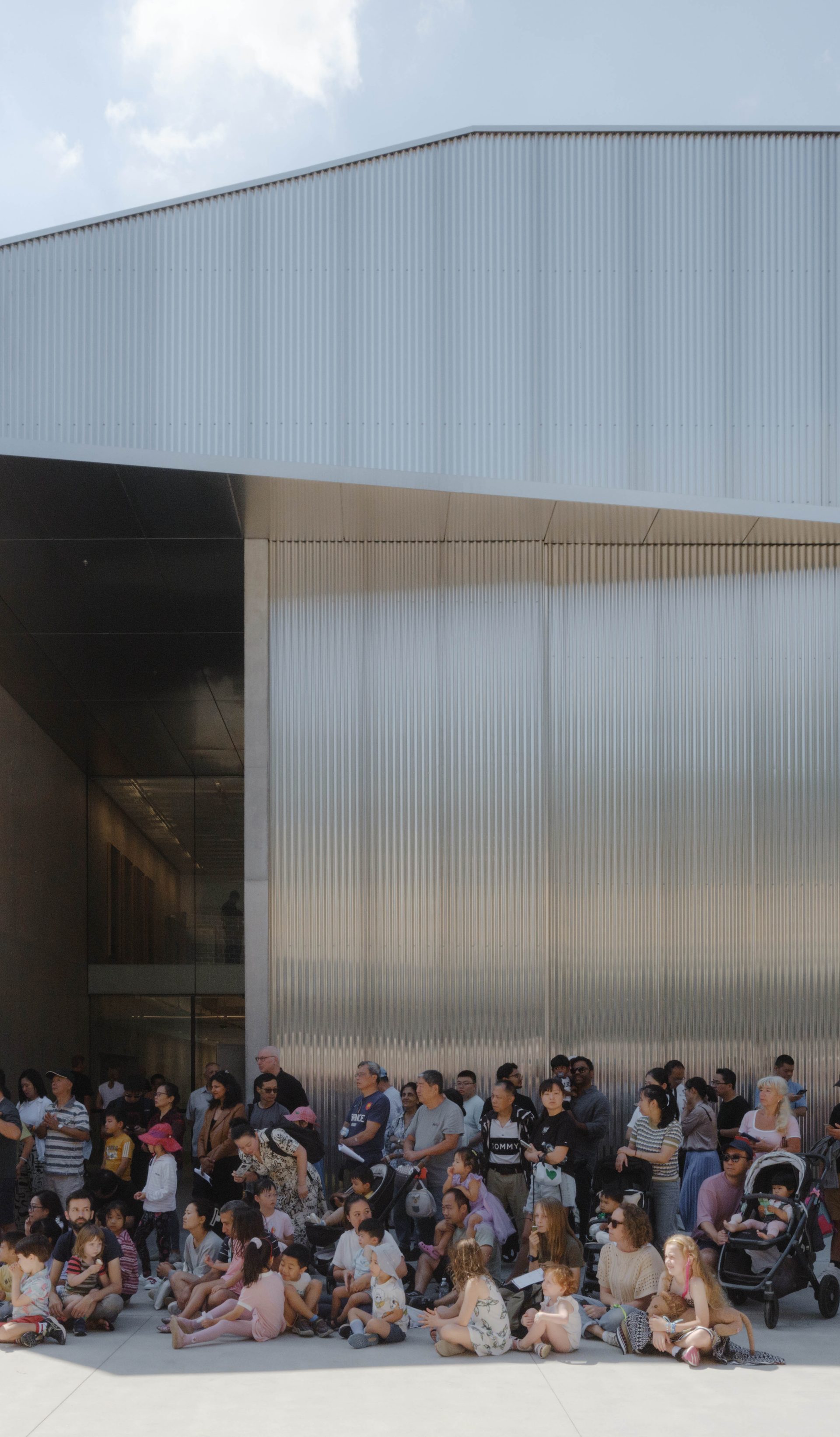 People waiting outside a building.