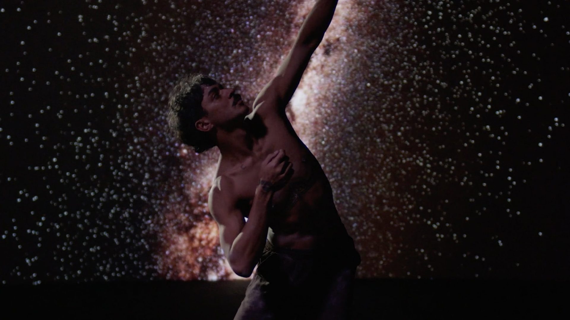 Dancing person in front of stars.